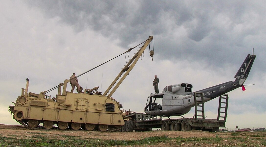 U.S. Marines prepare M88A2 wrecker to lift a helicopter hulk off the back of an M870M2 trailer during a ground tactical recovery of aircraft and personnel exercise with Combat Logistics Battalion 15, 15th Marine Expeditionary Unit, aboard Camp Pendleton, Calif., Jan. 29, 2015. As the 15th MEU’s combat logistics element, CLB-15 continues to hone its skills in environments similar to those they may find in future missions. (U.S. Marine Corps photo by Cpl. Steve H. Lopez/Released)