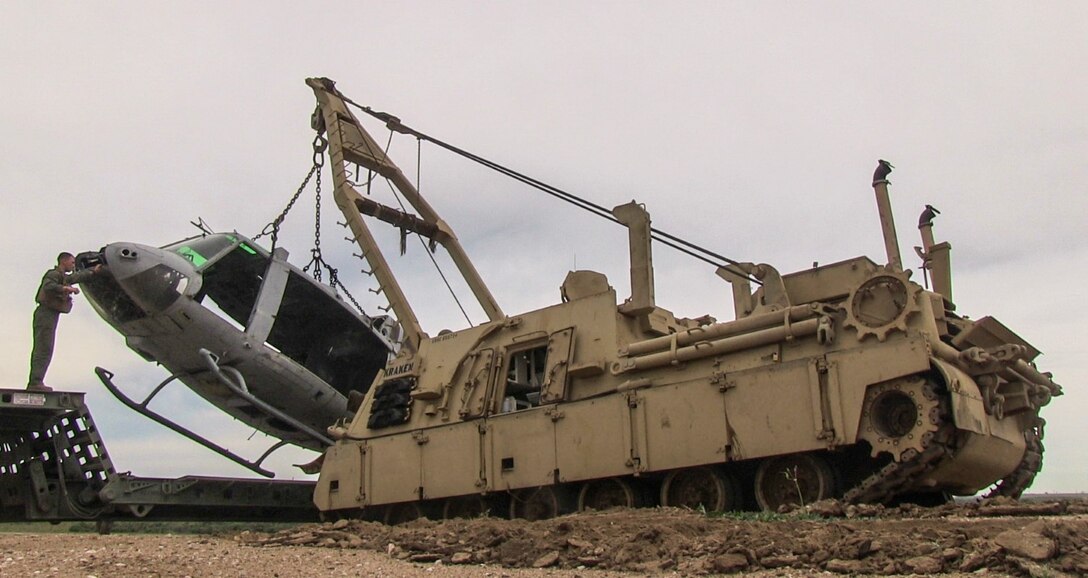 An M88A2 wrecker lifts a helicopter hulk off the back of a M870M2 trailer during a ground tactical recovery of aircraft and personnel exercise with Combat Logistics Battalion 15, 15th Marine Expeditionary Unit, aboard Camp Pendleton, Calif., Jan. 29, 2015. As the 15th MEU’s combat logistics element, CLB-15 continues to hone its skills in environments similar to those they may find in future missions. (U.S. Marine Corps photo by Cpl. Steve H. Lopez/Released)