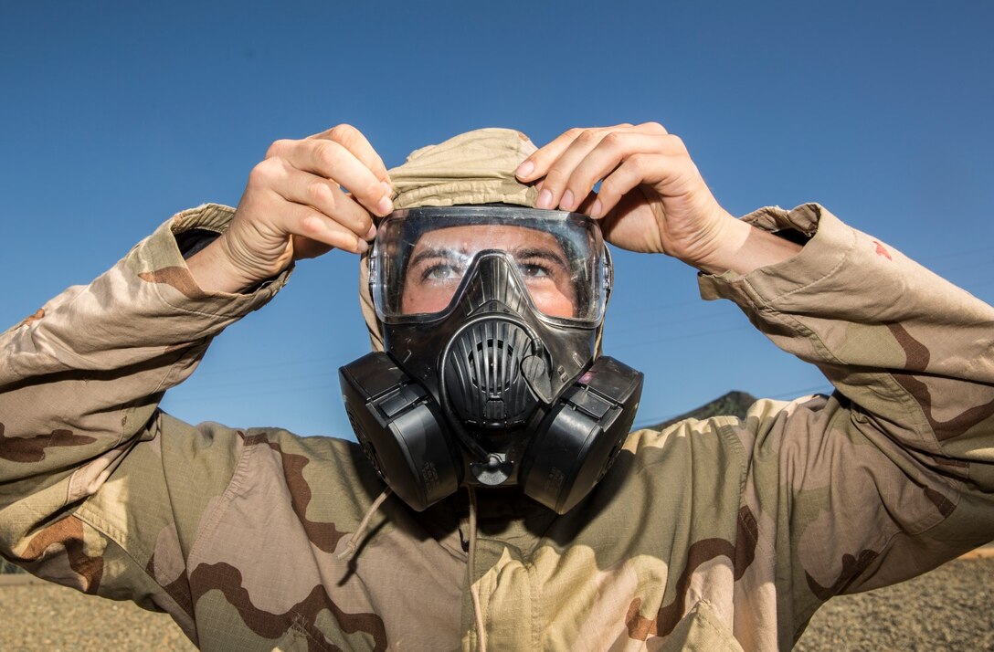 U.S. Marine Lance Cpl. Michael Reilly dons his mission oriented protective posture suit during a reconnaissance, surveillance and decontamination course aboard Camp Pendleton, Calif., Feb. 4, 2015. Reilly is a landing support specialist with Combat Logistics Battalion 15, 15th Marine Expeditionary Unit. As the logistics combat element for the 15th MEU, CLB-15 is training to ensure readiness for any situation they may encounter during their upcoming deployment this spring. (U.S. Marine Corps photo by Sgt. Emmanuel Ramos/Released)
