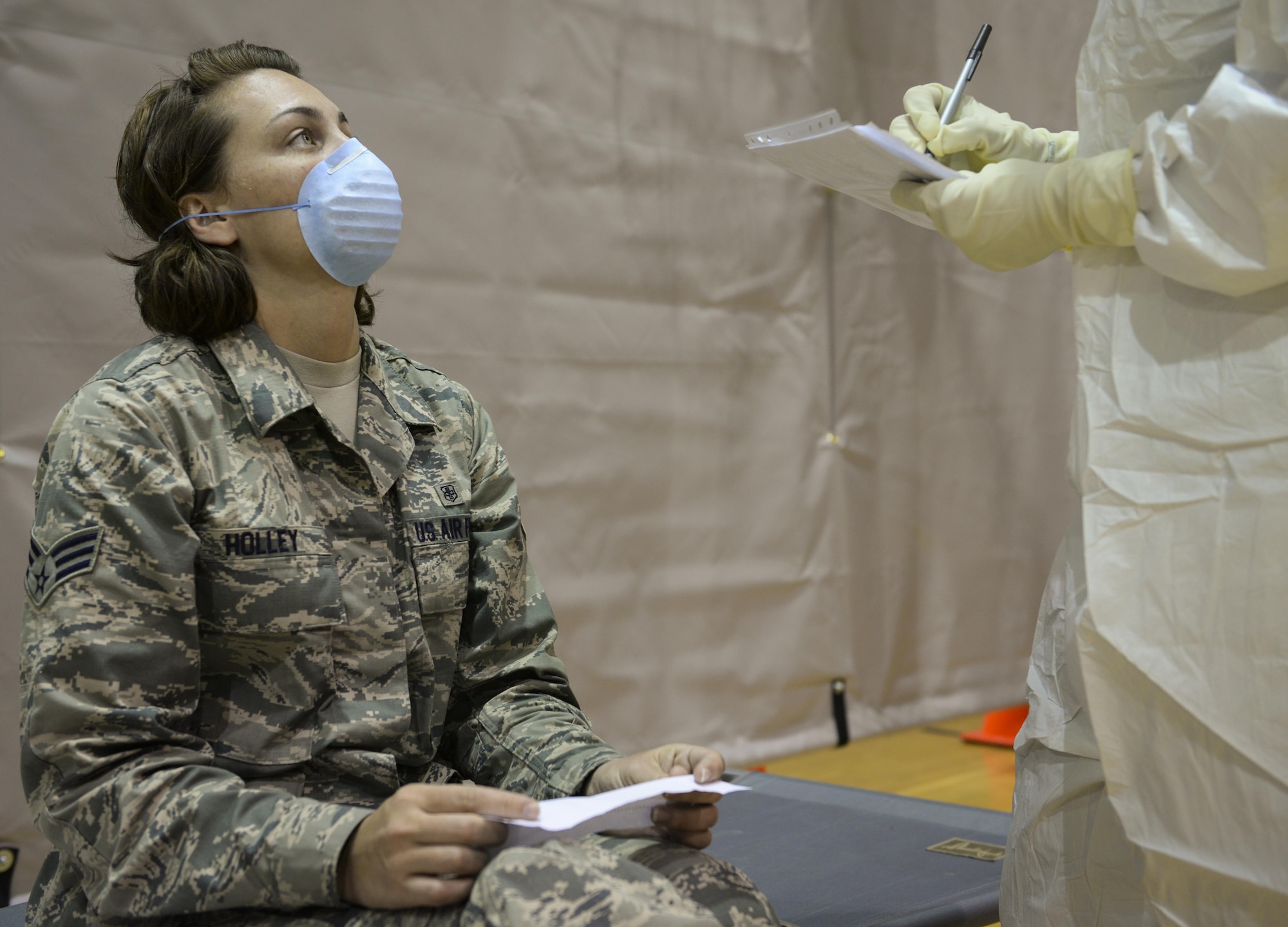 Senior Airman Rebecca Holley, 1st Special Operations Medical Group data quality manager, reports her simulated symptoms during a disease containment exercise at Hurlburt Field, Fla., Feb. 4, 2015. A total of 30 airmen were simulated patients. (U.S. Air Force photo Senior Airman Meagan Schutter/Released)