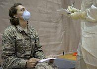 Senior Airman Rebecca Holley, 1st Special Operations Medical Group data quality manager, reports her simulated symptoms during a disease containment exercise at Hurlburt Field, Fla., Feb. 4, 2015. A total of 30 airmen were simulated patients. (U.S. Air Force photo Senior Airman Meagan Schutter/Released)