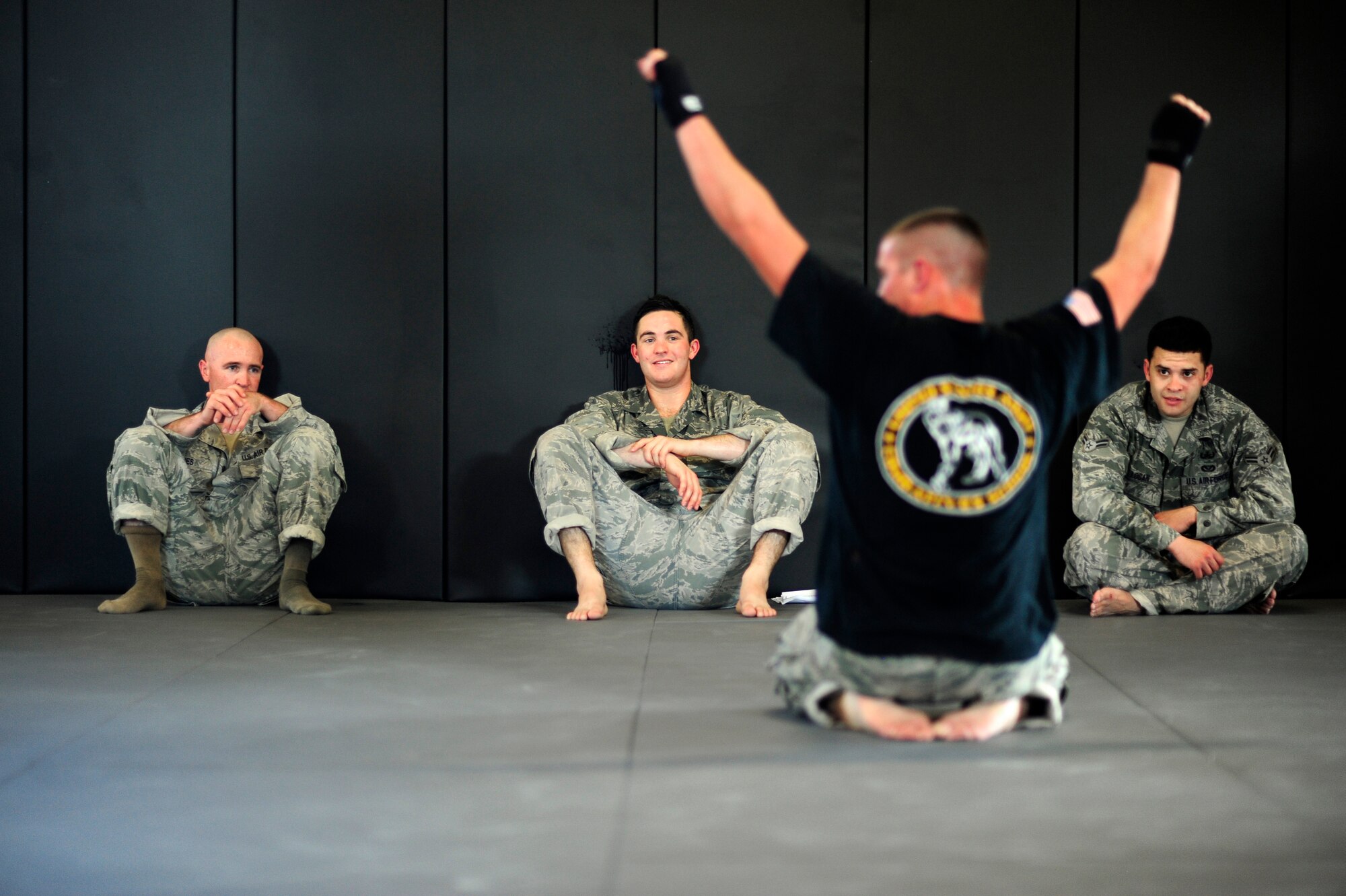 Staff Sgt. Mitchell Tate, 30th Civil Engineer Squadron water fuels systems maintenance shop craftsman and combatives instructor, congratulates his students after a full day of training during a combatives course, Feb. 5, 2015, Vandenberg Air Force Base, Calif. Once a CES based program, combative instructors are changing the combatives level 1 course into a base-wide program. (U.S. Air Force photo by Staff Sgt. Jim Araos/Released)