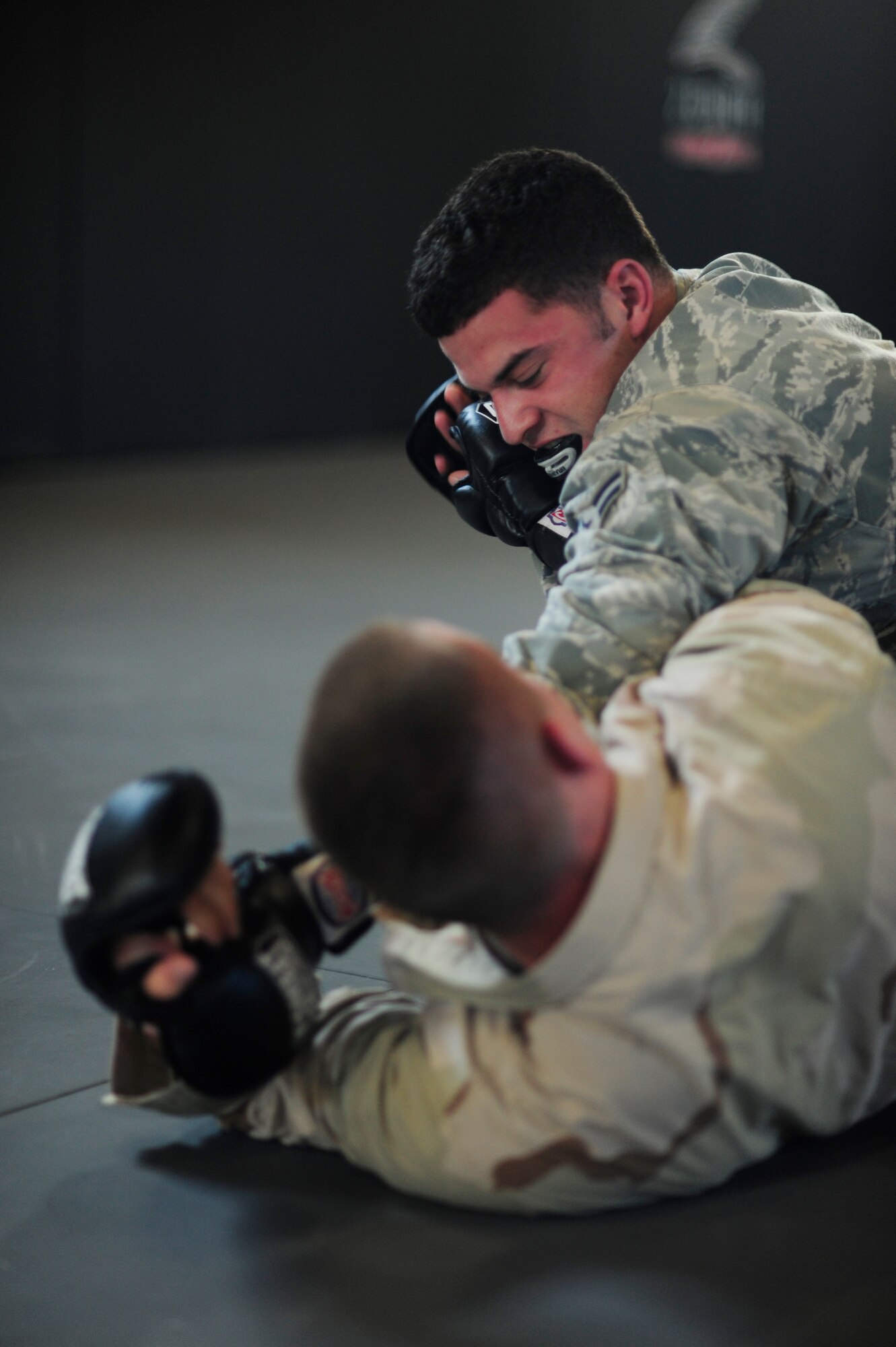 Airman 1st Class Ryan Logan, 30th Civil Engineer Squadron explosive ordnance disposal apprentice, wrestles with Staff Sgt. Mitchell Tate, 30th CES Squadron water fuels systems maintenance shop craftsman and combatives instructor, during a combatives course, Feb. 5, 2015, Vandenberg Air Force Base, Calif. Once a CES based program, combative instructors are changing the combatives level 1 course into a base-wide program. (U.S. Air Force photo by Staff Sgt. Jim Araos/Released)