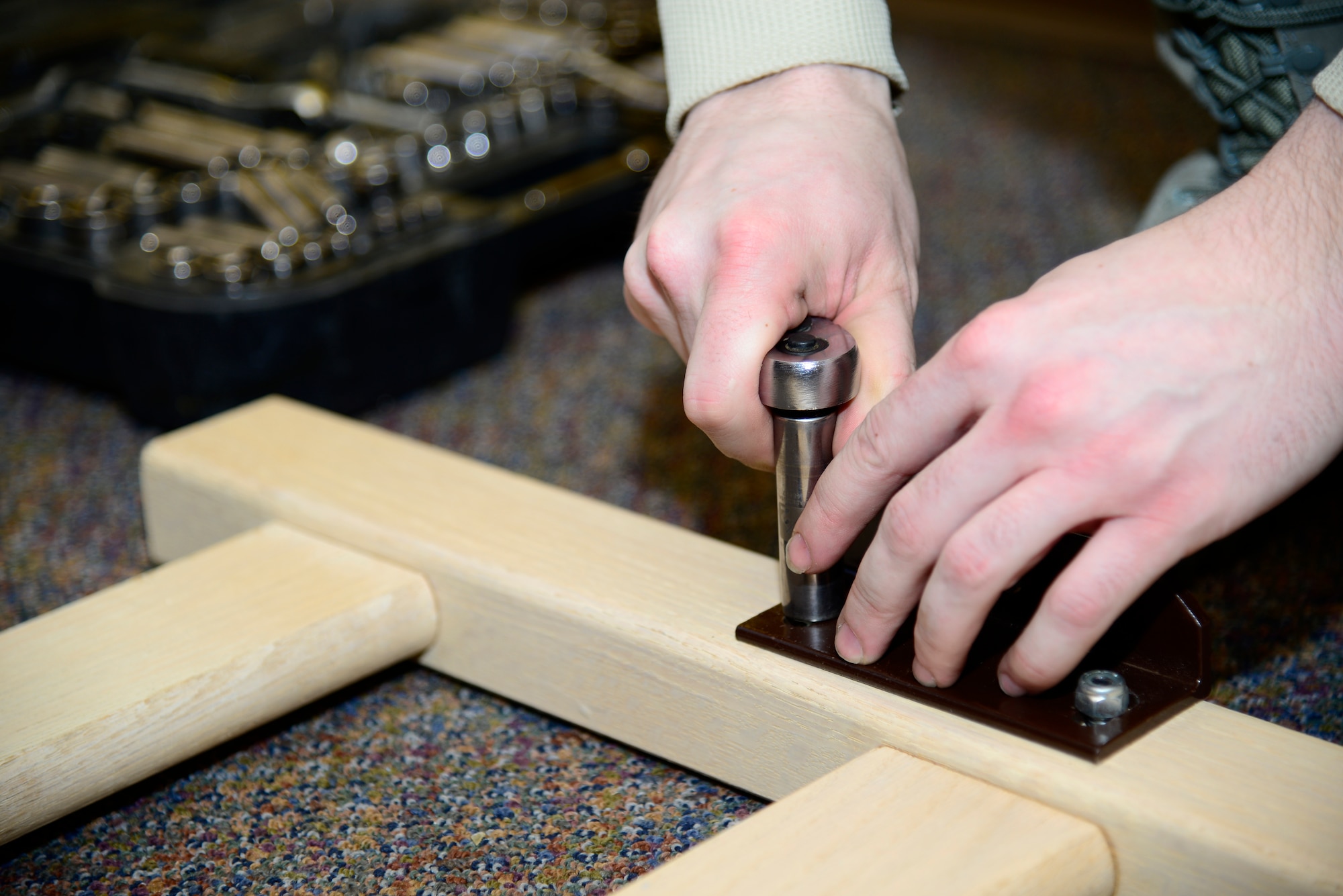 U.S. Airmen use tools to reassemble bedframes after a recent renovation for future dorm residents Feb. 5, 2014, at Eielson Air Force Base, Alaska. Fourteen Icemen volunteers helped with assembling and moving furniture after a recent renovation. (U.S. Air Force photo by Senior Airman Racheal E. Watson/Released)
