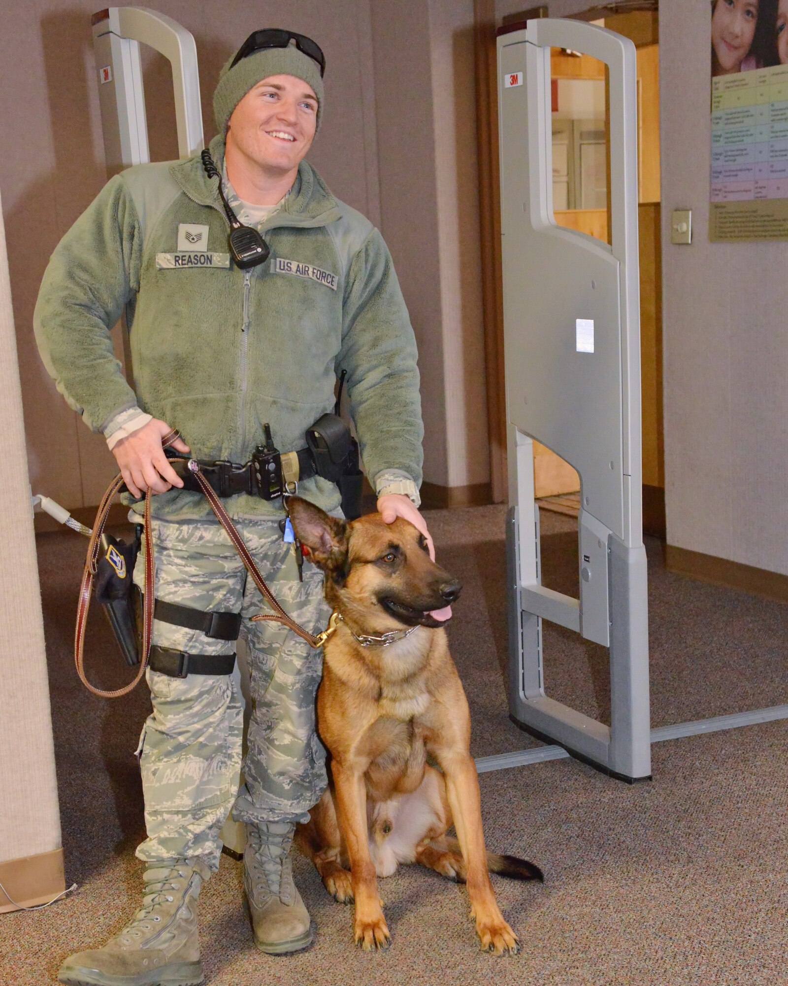 Staff Sgt. Aaron Reason of the 377th Security Forces Group and his dog prepare for a training exercise at Kirtland’s library, which is currently not in use. (Photo by Jamie Burnett)
