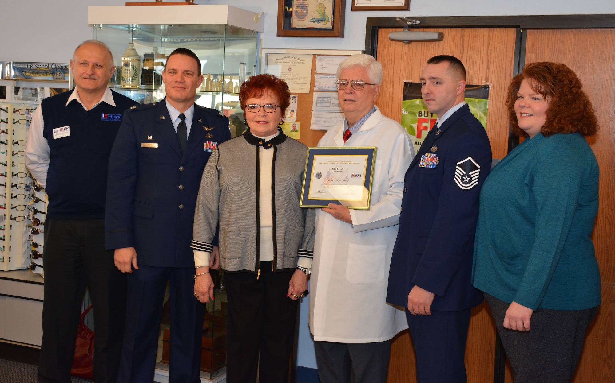 Del City, Okla. employer John Lassiter (middle) of Lassiter Drug Store accepts the Patriot award from the Employer Support of the Guard and Reserve and his employee Master Sgt. Zachary Walker (middle right). Also pictured is Retired Navy Capt. Gary Foster, Oklahoma ESGR Chairman (far left), Lt. Col. Stan Young, 72nd Aerial Port Squadron commander, Shirley Lassiter, and Shonda Lassiter (U.S. Air Force Photo/Maj. Jon Quinlan)                                            