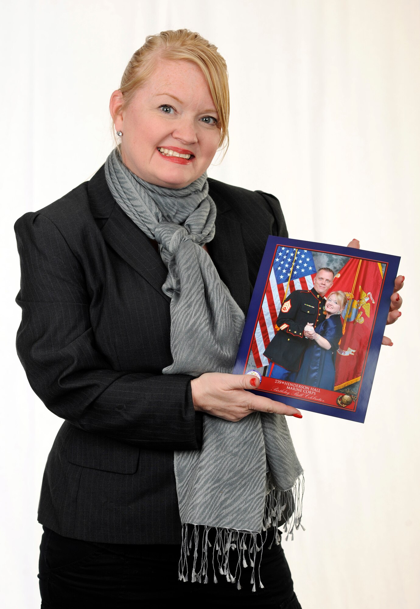 Holly McHugh, Joint Base Andrews, Md., Spouse of the Year for 2015, poses with a photo of her and her husband, Marine Staff Sgt. Jay McHugh at JBA, Feb. 5, 2015. (U.S. Air Force photo/Airman 1st Class Philip Bryant)
