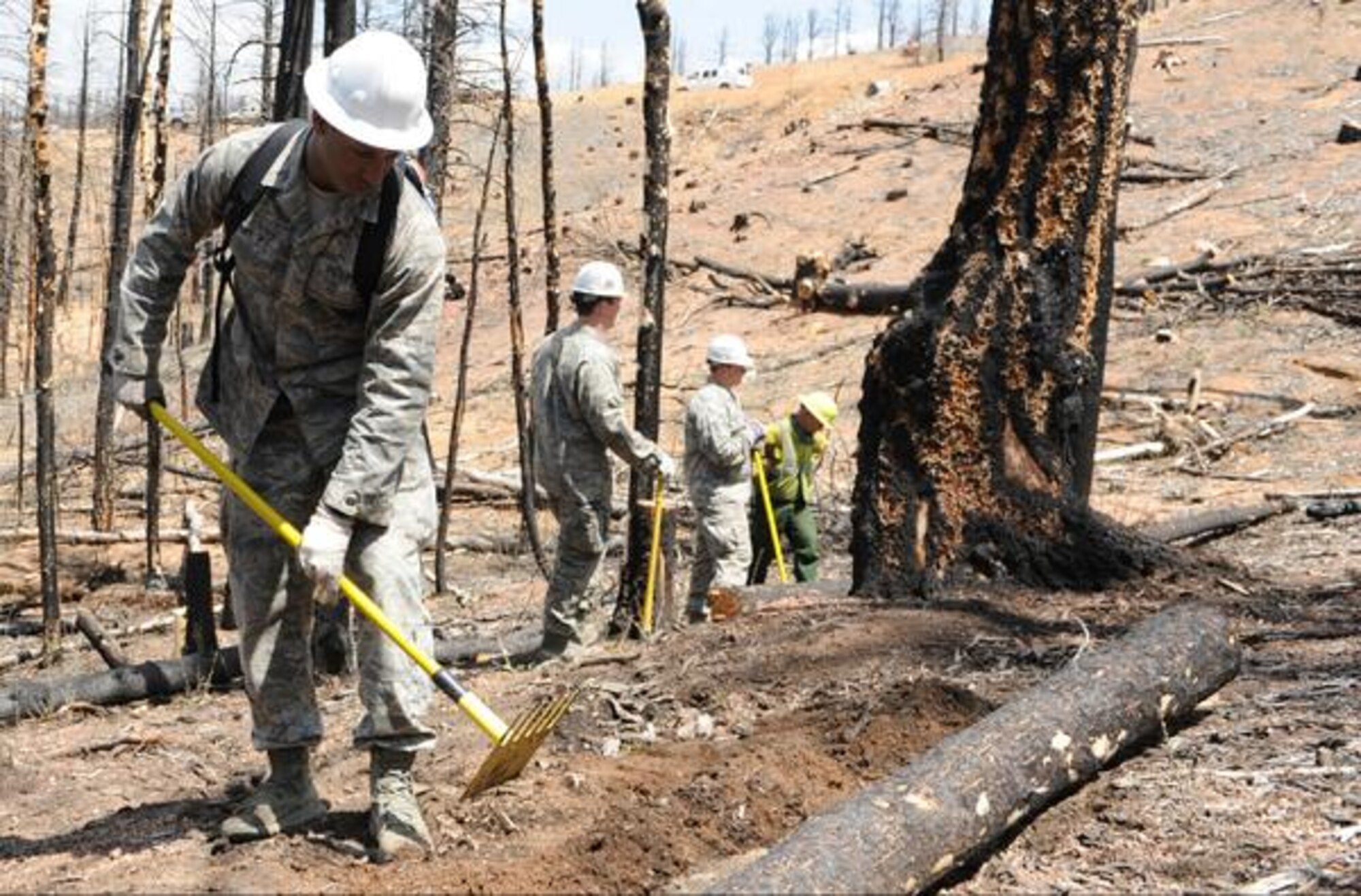 Cadet 1st Class Broam Hart helps move logs in order to prevent flooding after the Waldo Canyon fire in June, 2013. Hart participates in a variety of volunteer work, in addition to playing for the Academy football team and his academics. (Courtesy photo)