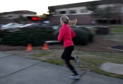 Jess Ramsey, spouse of 1st Lt. Phil Ramsey a member of the 628th Civil Engineering Squadron, races to the finish line during the monthly Fitness Challenge 5k on Joint Base Charleston, S.C., Feb. 6, 2015. Ramsey was the top female with a time of 19:17. (U.S. Air Force photo/Senior Airman Jared Trimarchi)