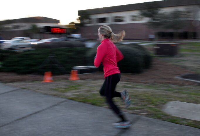 Jess Ramsey, spouse of 1st Lt. Phil Ramsey a member of the 628th Civil Engineering Squadron, races to the finish line during the monthly Fitness Challenge 5k on Joint Base Charleston, S.C., Feb. 6, 2015. Ramsey was the top female with a time of 19:17. (U.S. Air Force photo/Senior Airman Jared Trimarchi)