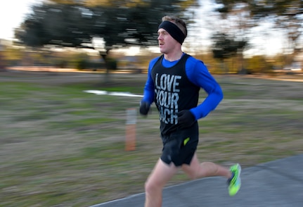 Airman 1st Class Beau McRoberts, a crew chief with the 437th Maintenance Squadron, races to the finish line during the monthly Fitness Challenge 5k on Joint Base Charleston, S.C., Feb. 6, 2015. McRoberts placed 1st with a time of 18:30. (U.S. Air Force photo/Senior Airman Jared Trimarchi)