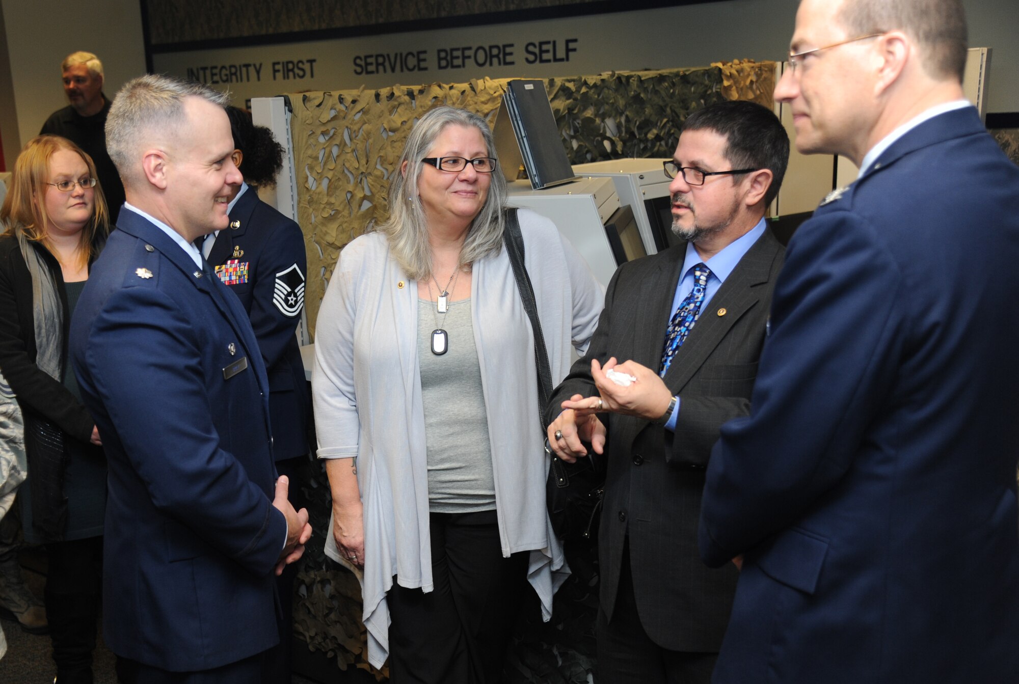 Lt. Col. Kevin Bray, 334th Training Squadron commander speaks with  retired Master Sgt. Richard Hansen, Sr., his wife Emily, as Col. David Radomski, 412th Test Wing vice commander, Edwards Air Force Base, Calif., listens after a room dedication ceremony to honor Senior Airman James Hansen, Feb. 4, 2015, at Cody Hall, Keesler Air Force Base, Miss.  Hansen was killed in combat in Iraq on Sept. 15, 2010.  He was an airfield management operations coordinator and received his training from the 334th Training Squadron here.  (U.S. Air Force photo by Kemberly Groue)