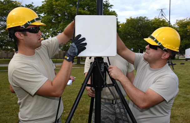 Tech. Sgt. Eric Anderson, left, and Master Sgt. Matthew Fisher, communications specialists for the Air National Guard's 115th Fighter Wing, perform initial acceptance testing on an Aruba flat panel antenna at Truax Field in Madison, Wis., September 14, 2014. The antenna is part of a Joint Incident Site Communications Capability (JISCC) package the unit will use to augment the states Chemical, Biological, Radiological, Nuclear, and high yield Explosive Enhanced Response Force Package (CERFP). (U.S. Air National Guard photo by Master Sgt. Paul Gorman/Released)