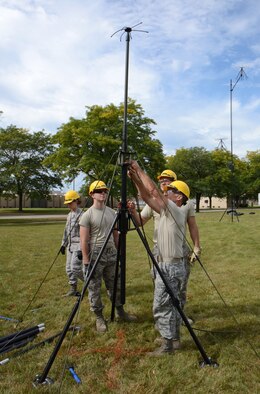 Members of the 115th Fighter Wing Communications Flight, perform initial acceptance testing on a 10 meter tactical UHF/VHF antenna at Truax Field in Madison, Wis. September 14, 2014. The antenna was received as part of a Joint Incident Site Communications Capability (JISCC) package the unit will use to augment the states Chemical, Biological, Radiological, Nuclear, and high yield Explosive Enhanced Response Force Package (CERFP). (U.S. Air National Guard photo by Master Sgt. Paul Gorman/Released)