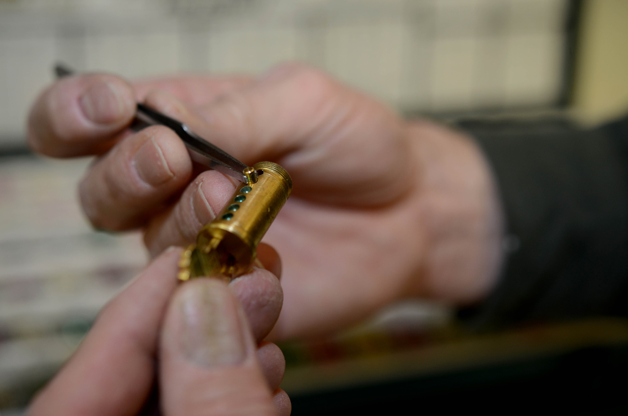 Jeff Kaul, 341st Civil Engineer Squadron locksmith, places tumblers back into a lock during a re-keying Feb. 3, 2015, at Malmstrom Air Force Base, Mont. Whenever a new key is needed for a building’s door, Kaul has to re-key the lock to make it compliant with the new key. (U.S. Air Force photo/Airman 1st Class Dillon Johnston)