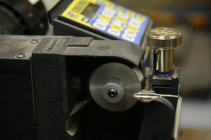An automatic key-cutting machine carves divots into a blank key Feb. 3, 2015, at Malmstrom Air Force Base, Mont. The machine is able to cut keys at a much faster rate than the older, hand-operated ones. (U.S. Air Force photo/Airman 1st Class Dillon Johnston)
