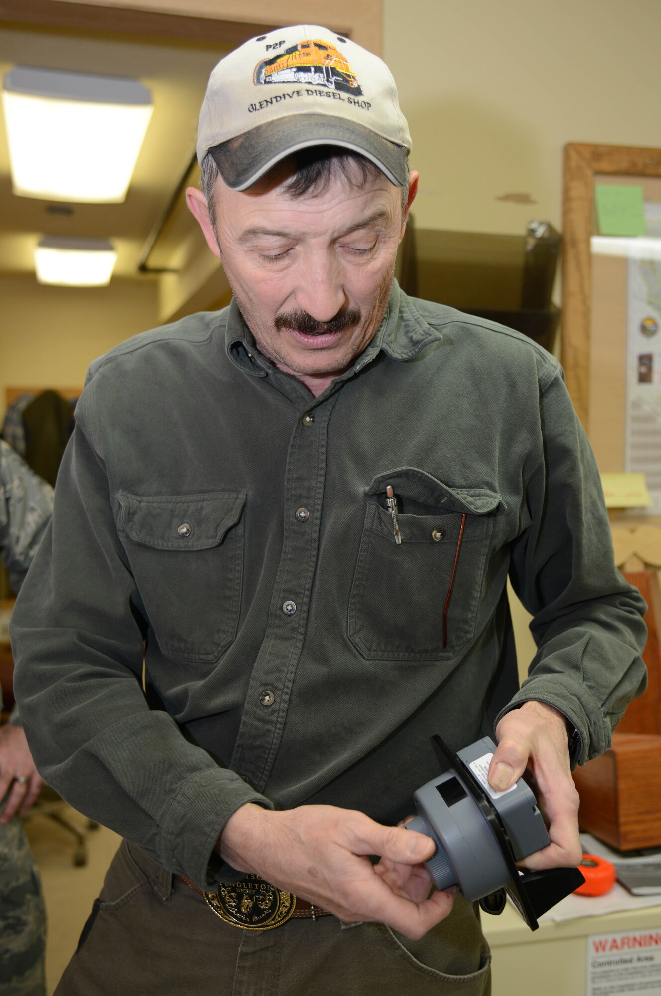 Jeff Kaul, 341st Civil Engineer Squadron locksmith, demonstrates how to use an electronic combination lock Feb. 3, 2015, at Malmstrom Air Force Base, Mont. Kaul maintains, installs and builds locks for all establishments on base. (U.S. Air Force photo/Airman 1st Class Dillon Johnston)