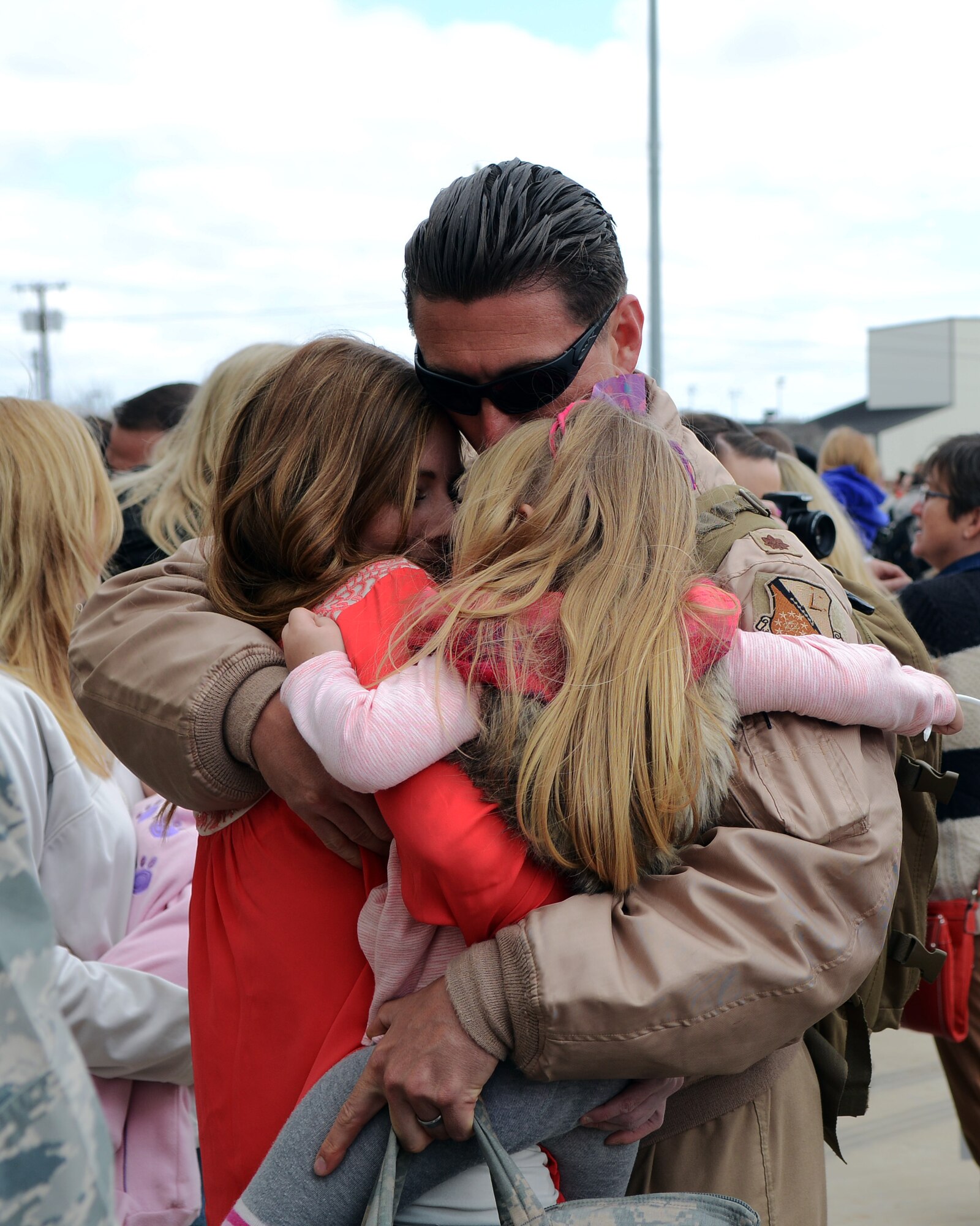 U.S. Air Force Maj. John, 9th Bomb Squadron, hugs his wife, Sabrina, and daughter, Sofia, after returning from a six-month deployment to Al Udeid Air Base, Qatar Feb. 1, 2015, at Dyess Air Force Base, Texas. The 9th BS, 7th Maintenance Group and 7th Operations Support Squadron took part in supporting Operation Enduring Freedom, Operation Freedom’s Sentinel and Operation Inherent Resolve. (U.S. Air Force photo by Airman 1st Class Kedesha Pennant/Released)