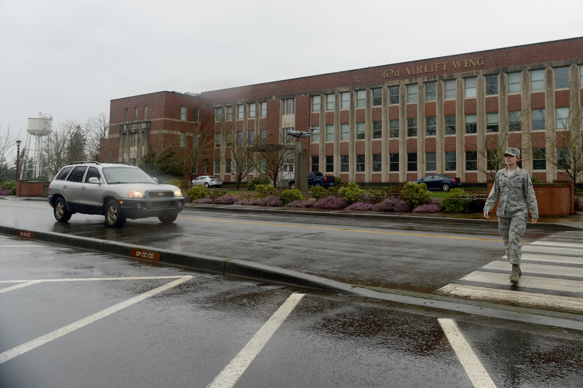Senior Airman Rebecca Blossom, 62nd Maintenance Squadron aerospace ground equipment technician, walks across a crosswalk Feb. 5, 2015, in front of building 100 at Joint Base Lewis-McChord, Wash. According to Washington State Law RCW 46.61.235, the driver of an approaching vehicle shall stop and remain stopped to allow pedestrians or bicyclists to cross the roadway within an unmarked or marked crosswalk. (U.S. Air Force photo\ A1C Keoni Chavarria) 
