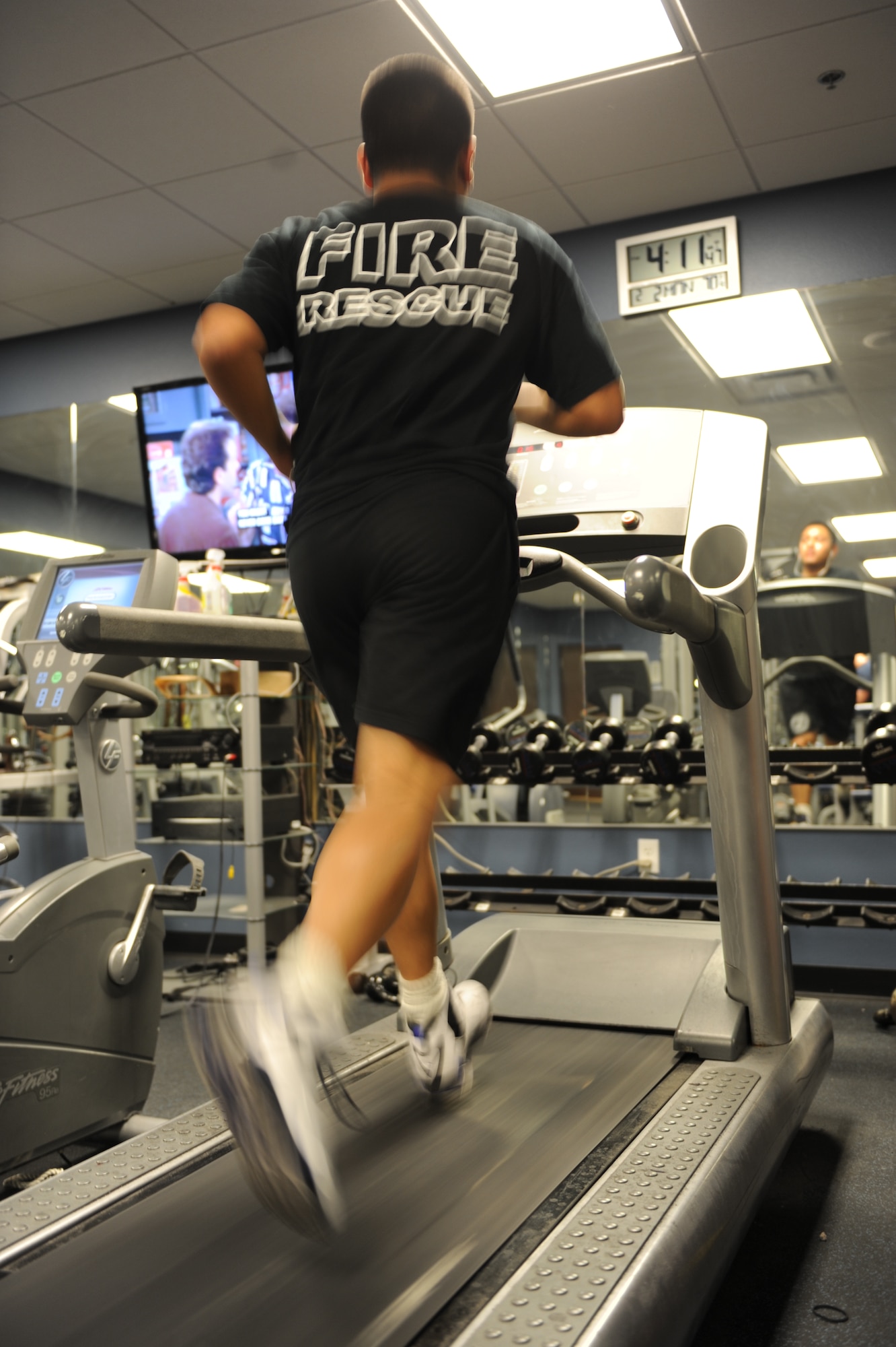 Senior Airman John Barron, 99th Civil Engineer Squadron fire protection journeymen, runs on the treadmill in the gym at Fire Station 1 at Nellis Air Force Base, Nev., Feb. 2, 2015. Fire fighters are required to adhere to a higher standard of physical fitness to be proficient in their duties. (U.S. Air Force photo by Staff Sgt. Victoria Sneed)
