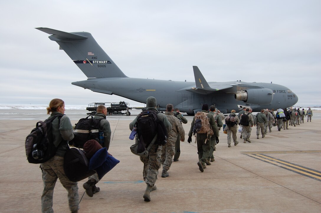 Members of the 140th Wing, Colorado Air National Guard, make their way into the C-17 that will take them on the first leg of their journey to South Korea February 4, 2015 at Buckley AFB, Colo. The 140th Wing is deploying as a theater security package in support of U.S. Pacific Command. (U.S. Air National Guard Photo by Capt. Kinder Blacke)
