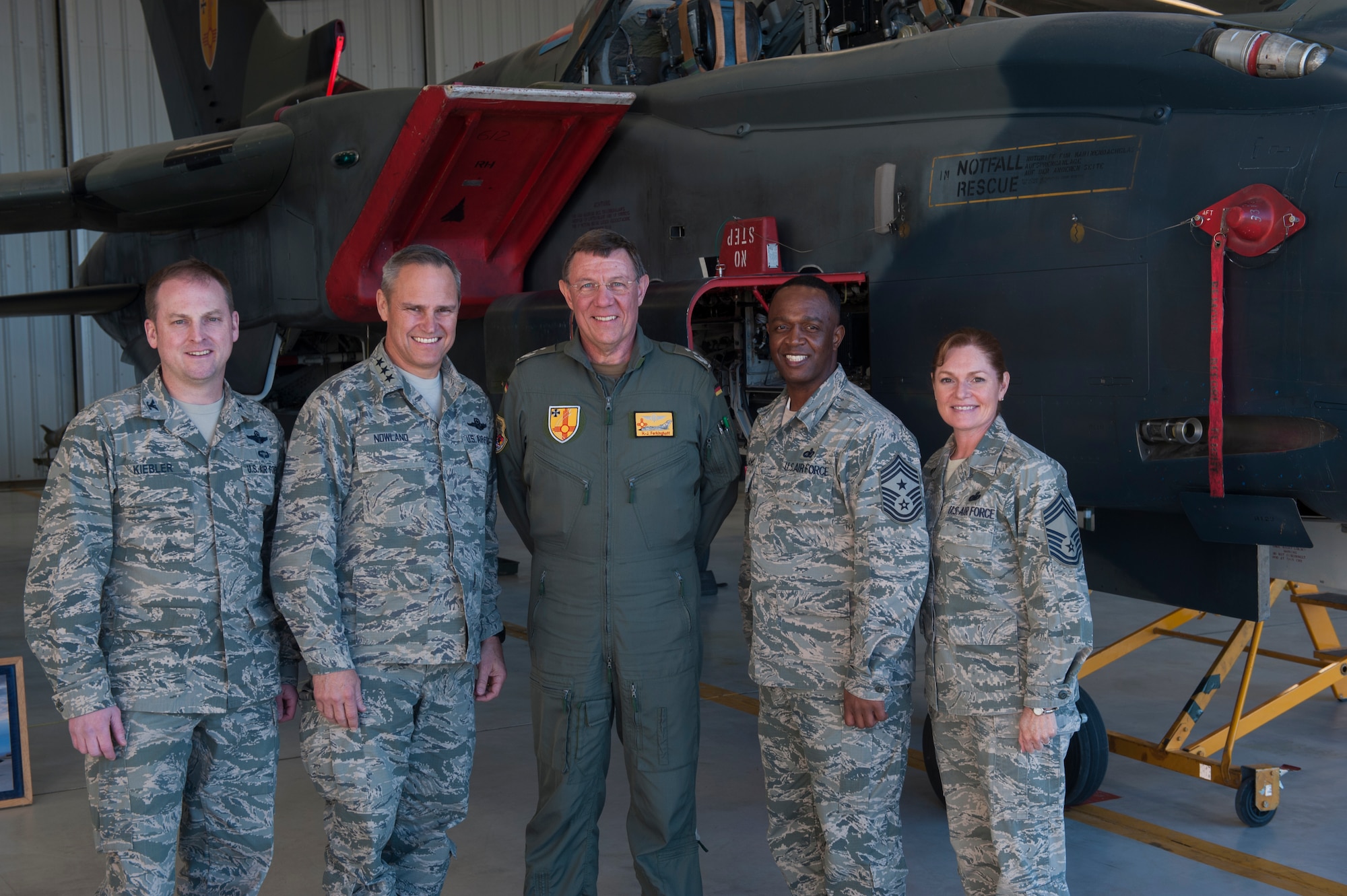Lt. Gen. Chris Nowland, 12th Air Force commander, Chief Master Sgt. Calvin Williams, 12 AF command chief, Col. Heinz J. Ferkinghoff German Air Force Flying Training Center commander, Col. Robert Kiebler 49th Wing commander and Chief Master Sgt. Wendy Rowe, 49th Wing interim command chief, pose for a group photo Feb. 4, 2015 at Holloman Air Force Base, N.M. During Nowland’s visit to Holloman, he toured many units on base, including the GAF FTC, where he learned more about Holloman’s relationship with the GAF. (U.S. Air Force photo by Airman 1st Class Emily A. Kenney/Released)