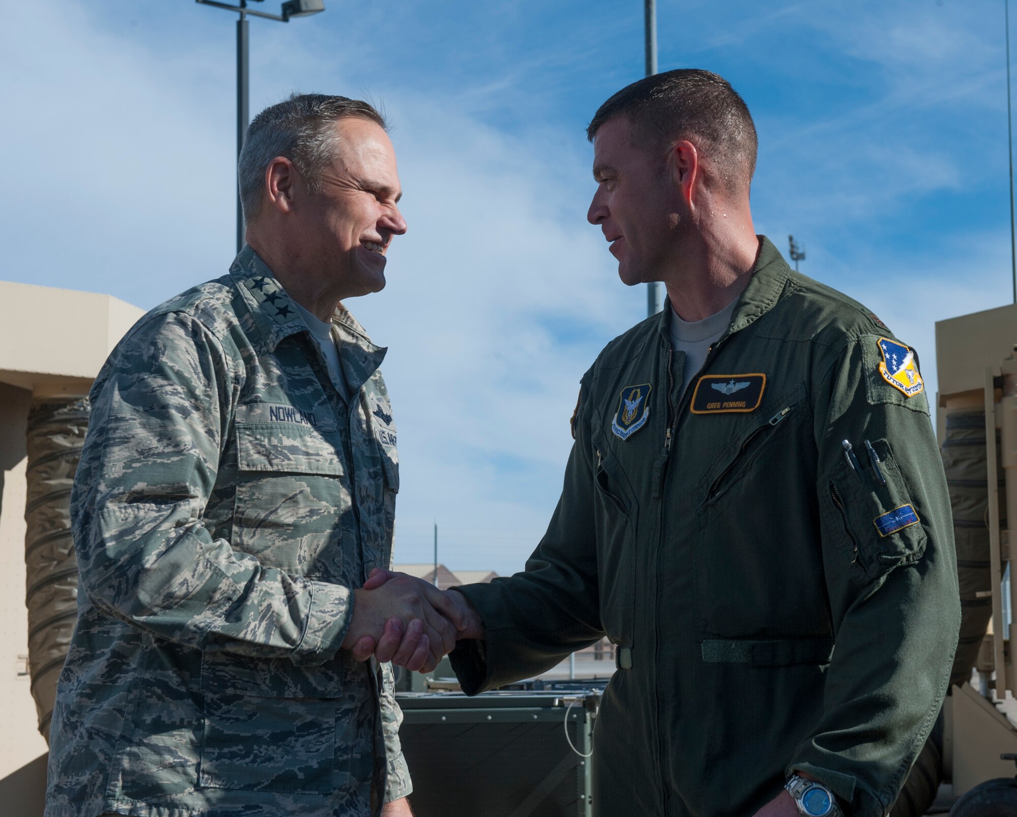 Lt. General Chris Nowland, 12th Air Force commander, congratulates Maj. Greg Penning, pilot with the Air Force Reserves 429th Air Combat Training Squadron, after Penning completed his final flight on Feb. 4, 2015 at Holloman Air Force Base, N.M. An Air Force tradition is to celebrate and congratulate a pilot’s “fini flight” is to be hosed down and soaked with champagne or water. (U.S. Air Force photo by Airman 1st Class Emily A. Kenney/Released)
