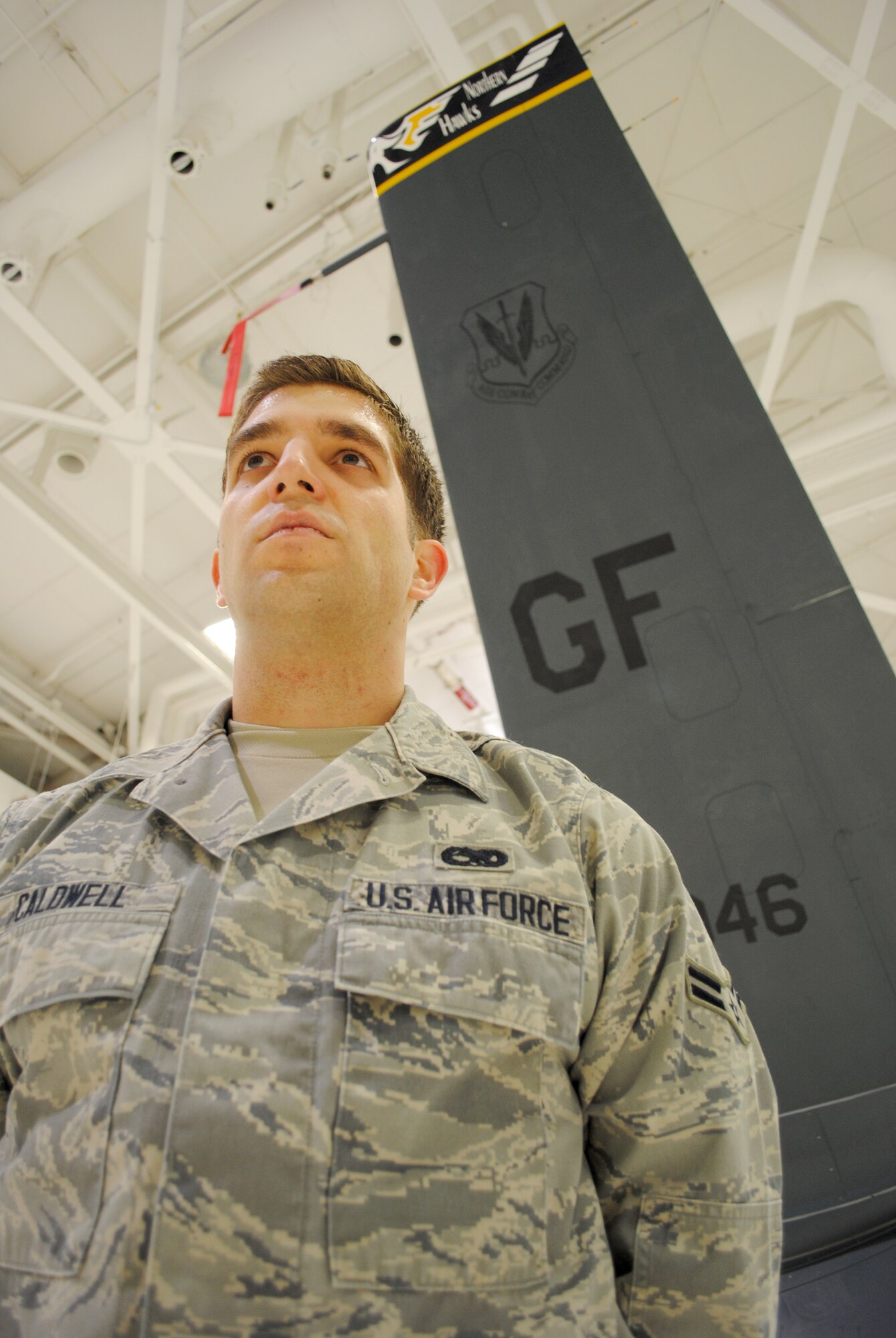 Airman 1st Class Aaron Caldwell, an Advanced Integrated Avionics Systems journeyman with the 69th Maintenance Squadron, poses for a photo next to a Block 40 RQ-4 Global Hawk inside a hangar on Grand Forks Air Force Base, N.D., Feb. 5, 2015. Airmen such as Caldwell attend and complete technical training courses for Electronic Principles and Avionics Systems in order to become aircraft maintainers.(U.S. Air Force photo/Staff Sgt. Luis Loza Gutierrez)