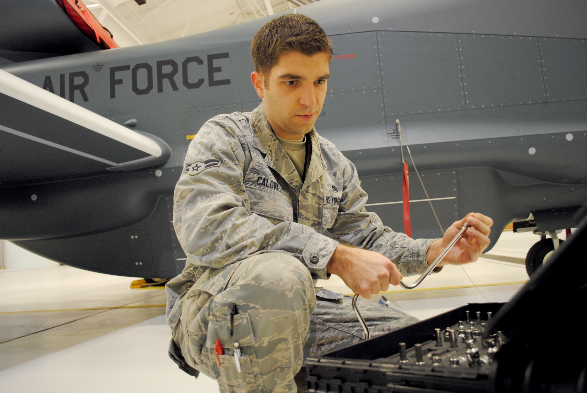 Airman 1st Class Aaron Caldwell, an Advanced Integrated Avionics Systems journeyman with the 69th Maintenance Squadron, reaches for a speed hand tool from his tool box in order to begin some routine maintenance work on a Block 40 RQ-4 Global Hawk inside a hangar on Grand Forks Air Force Base, N.D., Feb. 5, 2015. Aircraft maintainers such as Caldwell became familiarized with hundreds of special tools used to work on aircraft. The 24-year-old native from Independence, Mo., was named the Grand Forks AFB Warrior of the Week for the second week of February 2015. (U.S. Air Force photo/Staff Sgt. Luis Loza Gutierrez)