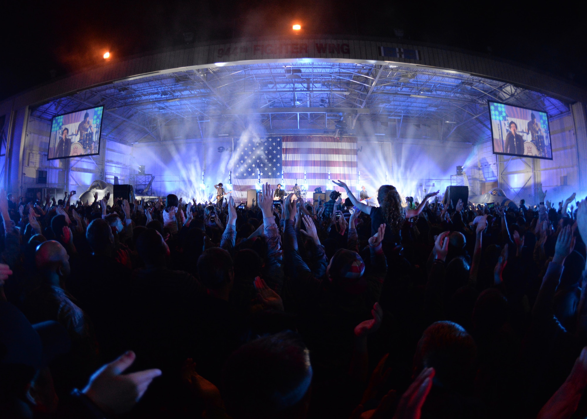 Luke Thunderbolts wave as rock group Fall Out Boy performs one of their hit songs during the Papa John’s/VH1 concert. (U.S. Air Force photo/Staff Sgt. Nestor Cruz)