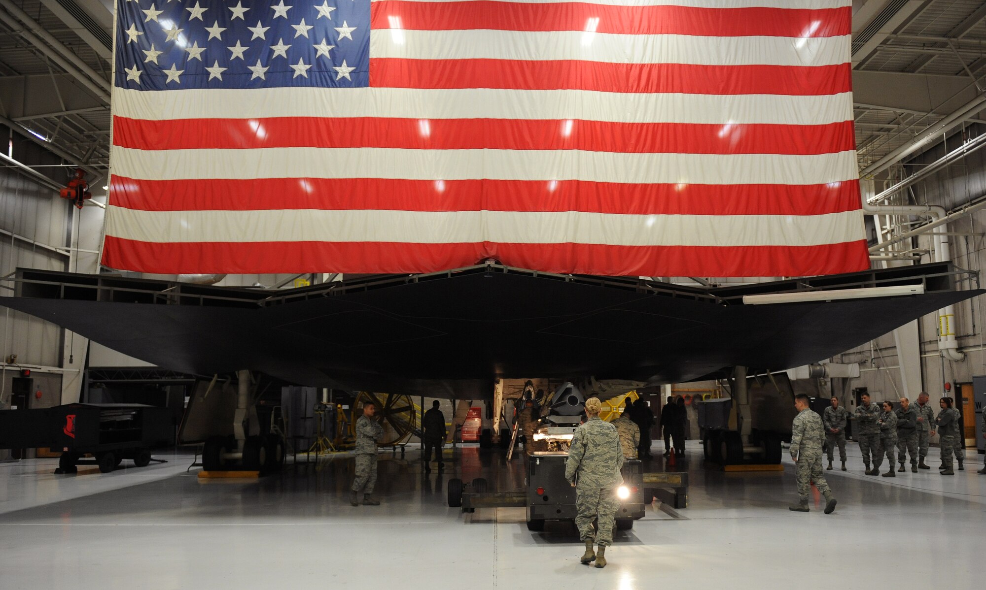 Evaluators and spectators look on during a weapons load competition at Whiteman Air Force Base, Mo., Jan 23, 2015. The competition is designed to showcase the teamwork, precision and attention to detail amongst Airmen in support of nuclear deterrence and global strike operations. (U.S. Air Force photo by Airman 1st Class Joel Pfiester/Released)

