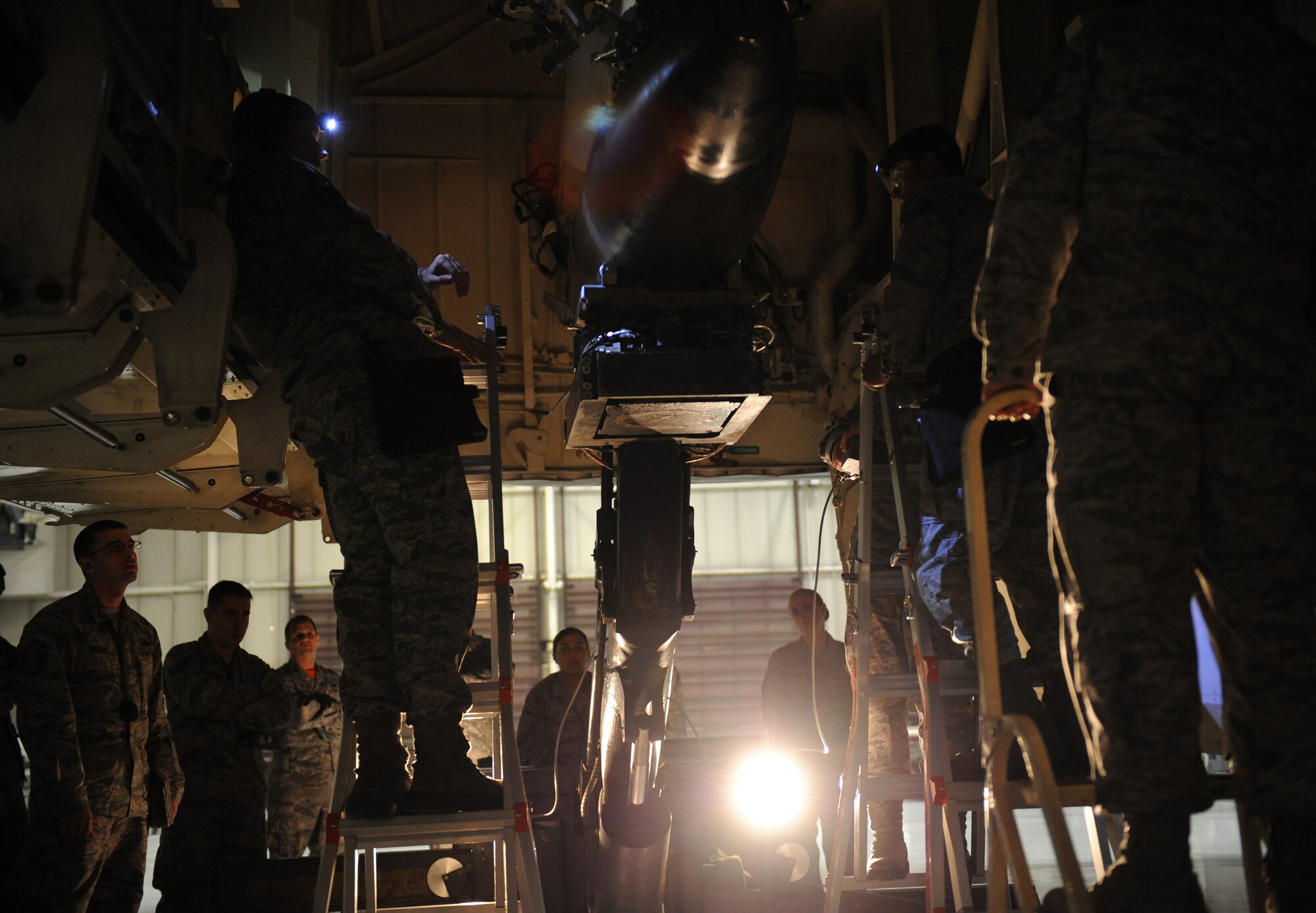 Members of the 131st Aircraft Maintenance Squadron load an MK-84 into the B-2 Spirit weapons load trainer during a weapons load competition at Whiteman Air Force Base, Mo., Jan. 23, 2015. Total force Airmen from the 131st Bomb Wing, 13th and 393rd Aircraft Maintenance Units competed in the competition. (U.S. Air Force photo by Airman 1st Class Joel Pfiester/Released)