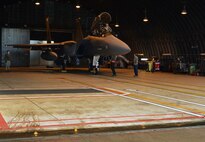 Airmen assigned to the 494th Aircraft Maintenance Unit prepare an F-15E Strike Eagle for takeoff at Royal Air Force Lakenheath, England, Feb. 4, 2015. The 494th Fighter Squadron participated in a three-day exercise to evaluate their response time to simulated alerts.  (U.S. Air Force photo by Airman 1st Class Dawn M. Weber/Released)