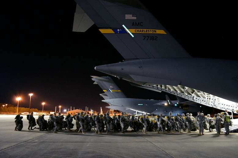 U.S. Army paratroopers from the 2nd Brigade Combat Team, 82nd Airborne Division, load onto an U.S. Air Force C-17 Globemaster III transport aircraft from the 437th Airlift Wing, Joint Base Charleston, South Carolina, on Green Ramp, Pope Army Airfield, North Carolina, Jan. 27, 2015, during an Emergency Deployment Readiness Exercise. Five hundred paratroopers were airdropped onto Wright Army Airfield, Fort Stewart, Georgia, from five C-17 transport aircraft 18 hours after notification. As the nucleus of the nation's Global Response Force, the 82nd Airborne Division provides a strategic hedge for combatant commanders with a responsive, agile and operationally significant response force that is flexible in size and composition to accomplish missions anywhere in the world. Air Mobility Command's participation also illustrates the critical partnership between Mobility Air Forces and the U.S. Army by exercising Joint Forcible Entry: the capability of rapidly introducing forces into hostile environments to conduct operations—whether combat or humanitarian support. (U.S. Air Force photo/Marvin Krause)