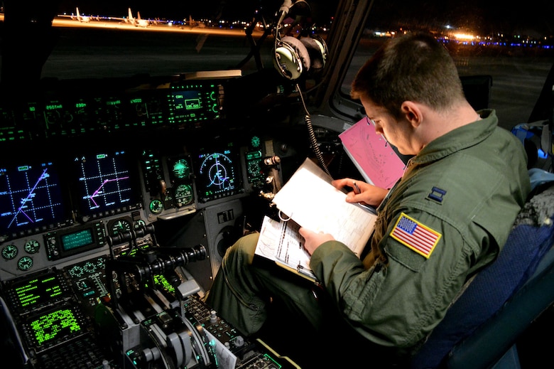 U.S. Air Force Capt. Matt Kettler, a C-17 Globemaster III transport aircraft pilot assigned to the 17th Airlift Squadron, Joint Base Charleston, South Carolina, conducts preflight checks during an Emergency Deployment Readiness Exercise at Green Ramp, Pope Army Airfield, North Carolina, Jan. 27, 2015. Five hundred U.S. Army paratroopers from the 2nd Brigade Combat Team, 82nd Airborne Division, were airdropped onto Wright Army Airfield, Fort Stewart, Georgia, from five C-17 transport aircraft 18 hours after notification. As the nucleus of the nation's Global Response Force, the 82nd Airborne Division provides a strategic hedge for combatant commanders with a responsive, agile and operationally significant response force that is flexible in size and composition to accomplish missions anywhere in the world. Air Mobility Command's participation also illustrates the critical partnership between Mobility Air Forces and the U.S. Army by exercising Joint Forcible Entry: the capability of rapidly introducing forces into hostile environments to conduct operations—whether combat or humanitarian support. (U.S. Air Force photo/Marvin Krause)