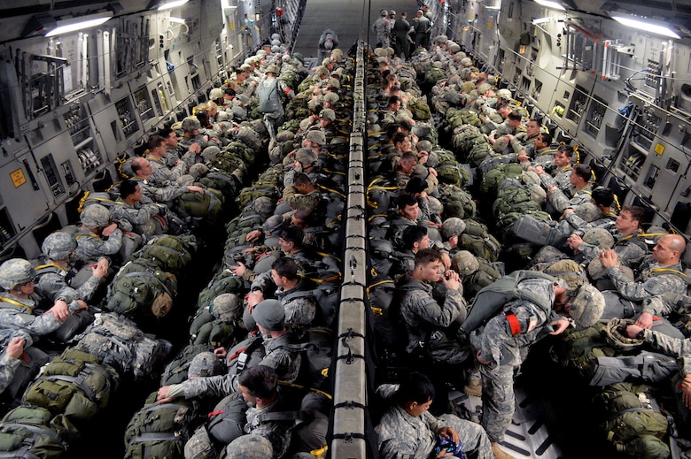 U.S. Army paratroopers from the 2nd Brigade Combat Team, 82nd Airborne Division, load onto an U.S. Air Force C-17 Globemaster III transport aircraft from the 437th Airlift Wing, Joint Base Charleston, South Carolina, on Green Ramp, Pope Army Airfield, North Carolina, Jan. 27, 2015, during an Emergency Deployment Readiness Exercise. Five hundred paratroopers from the 2nd Brigade Combat Team, 82nd Airborne Division, were airdropped onto Wright Army Airfield, Fort Stewart, Georgia, from five C-17 transport aircraft 18 hours after notification. As the nucleus of the nation's Global Response Force, the 82nd Airborne Division provides a strategic hedge for combatant commanders with a responsive, agile and operationally significant response force that is flexible in size and composition to accomplish missions anywhere in the world. Air Mobility Command's participation also illustrates the critical partnership between Mobility Air Forces and the U.S. Army by exercising Joint Forcible Entry: the capability of rapidly introducing forces into hostile environments to conduct operations—whether combat or humanitarian support. (U.S. Air Force photo/Marvin Krause)