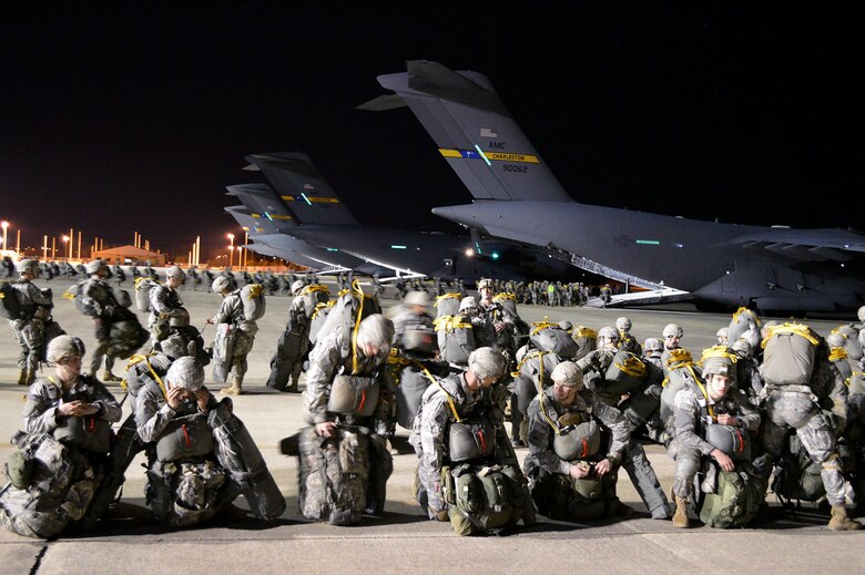 U.S. Army paratroopers from the 2nd Brigade Combat Team, 82nd Airborne Division, load onto U.S. Air Force C-17 Globemaster III transport aircraft from the 437th Airlift Wing, Joint Base Charleston, South Carolina, on Green Ramp, Pope Army Airfield, North Carolina, Jan. 27, 2015, during an Emergency Deployment Readiness Exercise. Five hundred paratroopers were airdropped onto Wright Army Airfield, Fort Stewart, Georgia, from five C-17 transport aircraft 18 hours after notification. As the nucleus of the nation's Global Response Force, the 82nd Airborne Division provides a strategic hedge for combatant commanders with a responsive, agile and operationally significant response force that is flexible in size and composition to accomplish missions anywhere in the world. Air Mobility Command's participation also illustrates the critical partnership between Mobility Air Forces and the U.S. Army by exercising Joint Forcible Entry: the capability of rapidly introducing forces into hostile environments to conduct operations—whether combat or humanitarian support. (U.S. Air Force photo/Marvin Krause)