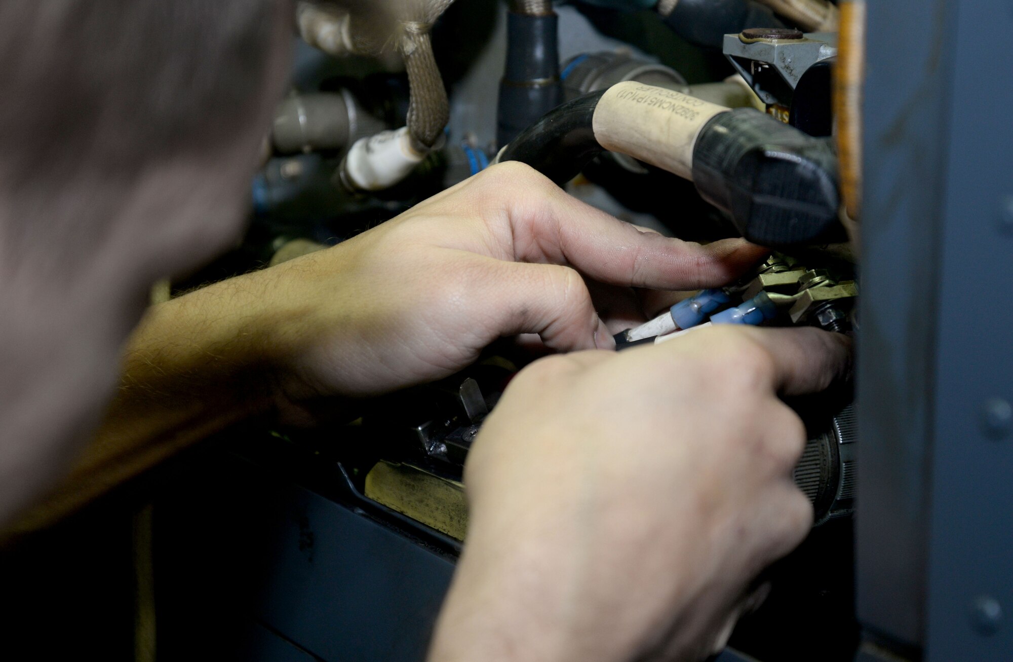 U.S. Air Force Staff Sgt. Joel Miller, 352nd Special Operations Maintenance Squadron electrical environmental systems technician from Goshen, Ind., repairs wiring on a CV-22B Osprey Jan. 29, 2015, on RAF Mildenhall, England. The CV-22 can perform missions that normally would require both fixed-wing and rotary-wing aircraft. Vital to the special operations mission, maintainers are prepared to fix the aircraft when necessary ensuring the Ospreys are ready to fly at all times. (U.S. Air Force photo by Senior Airman Kate Maurer/Released)