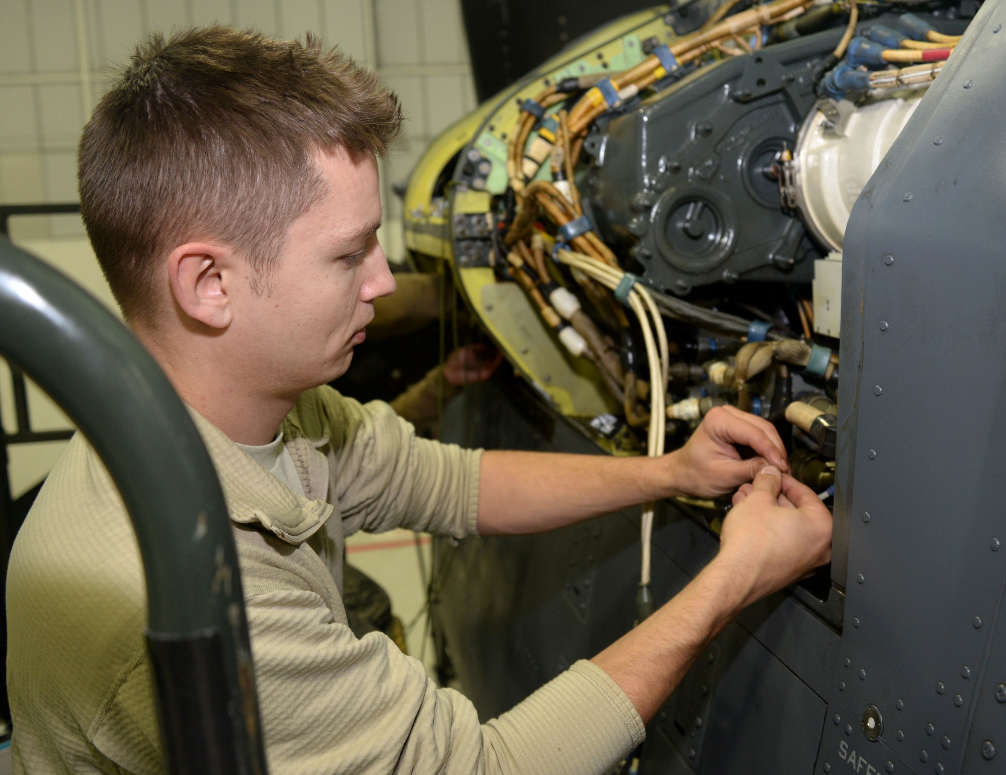 U.S. Air Force Staff Sgt. Joel Miller, 352nd Special Operations Maintenance Squadron electrical environmental systems technician from Goshen, Ind., repairs wiring on a CV-22B Osprey Jan. 29, 2015, on RAF Mildenhall, England. The CV-22 can perform missions that normally would require both fixed-wing and rotary-wing aircraft. Vital to the special operations mission, maintainers are prepared to fix the aircraft when necessary ensuring the Ospreys are ready to fly at all times. (U.S. Air Force photo by Senior Airman Kate Maurer/Released)