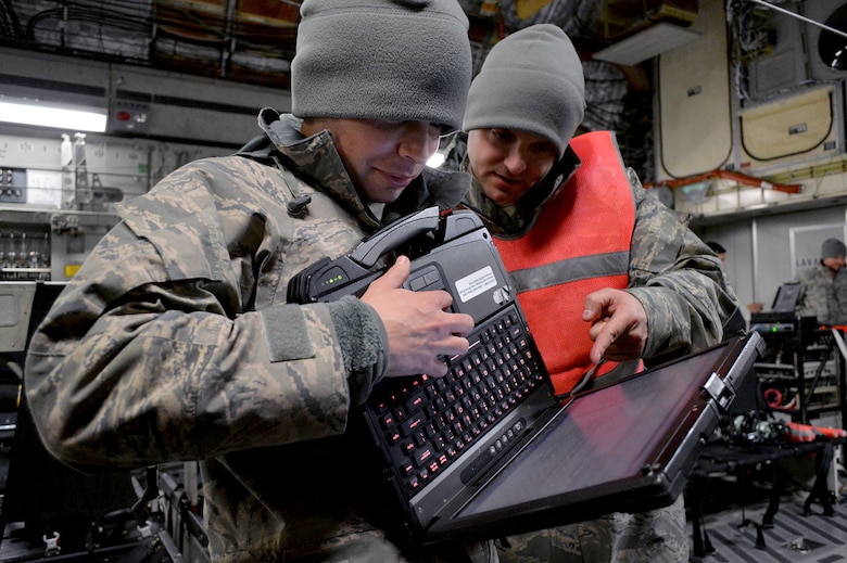 U.S. Air Force Staff Sgt. Joel Hamlet, left, an aircraft electrical and navigation systems craftsman and Staff Sgt. Michael Kozak, right, an aircraft communications and navigation systems craftsman, both from the 43rd Aircraft Maintenance Squadron, Pope Army Airfield, North Carolina, review C-17 Globemaster III aircraft technical orders during an Emergency Deployment Readiness Exercise on Jan. 27, 2015. By interacting and working closely with their joint partners, Mobility Airmen are able to develop refinements to processes and procedures that can potentially enhance the effectiveness of real-world operations. (U.S. Air Force photo/Marvin Krause)