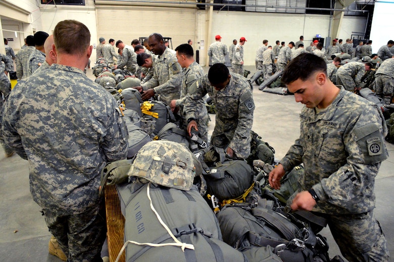 U.S. Army paratroopers from the 2nd Brigade Combat Team, 82nd Airborne Division, prepare their parachutes and equipment during an Emergency Deployment Readiness Exercise at Green Ramp, Pope Army Airfield, North Carolina, on Jan. 27, 2015. The Emergency Deployment Readiness Exercise assesses the 82nd Airborne Division’s deployment readiness tasks for a no-notice deployment—including alert, outload procedures, and deployment—tasks that are necessary to their mission success as the Joint Forcible Entry component of the nation's Global Response Force. (U.S. Air Force photo/Marvin Krause) 