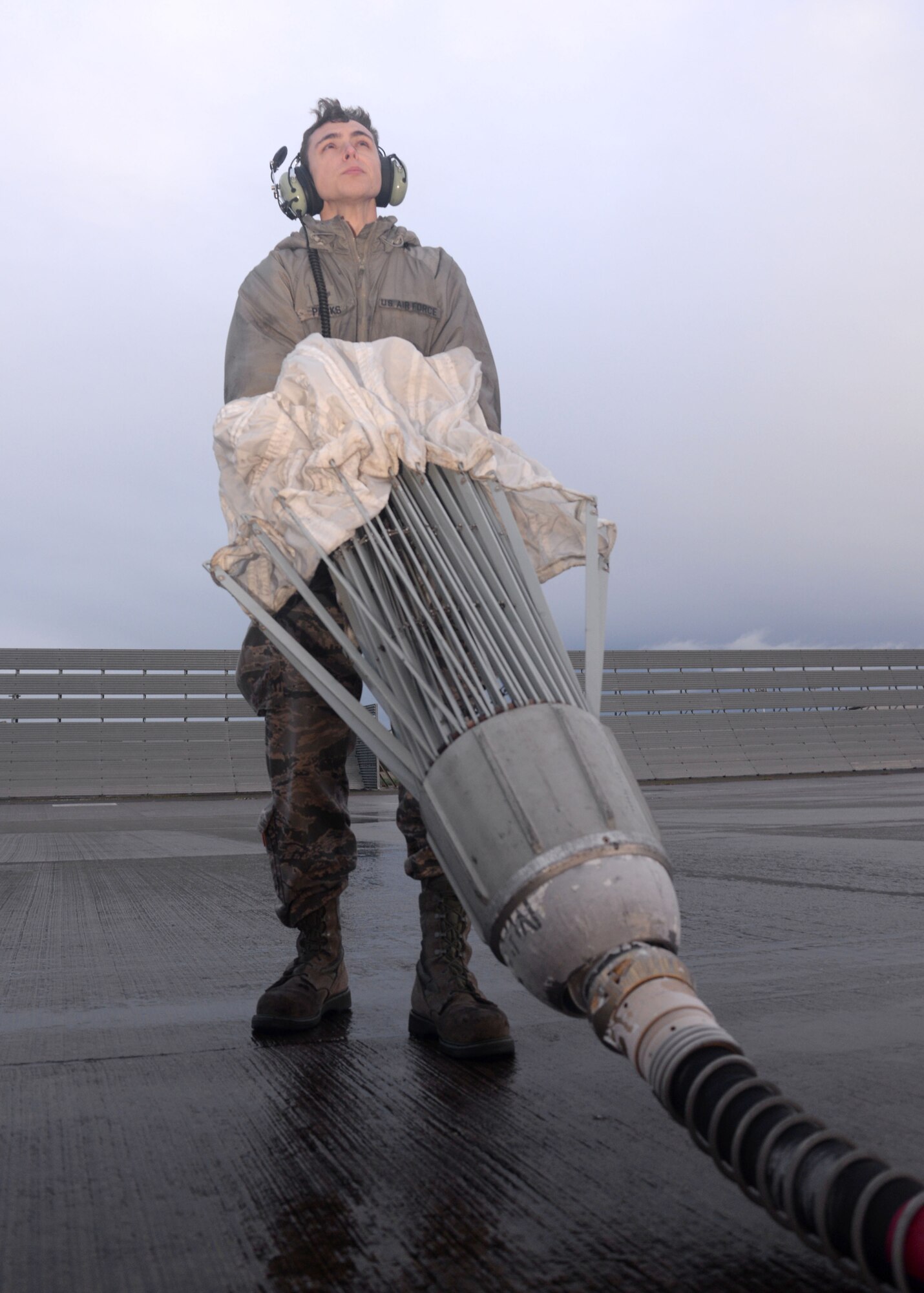 U.S. Air Force Senior Airman Warren Park, 352nd Special Operations Maintenance Squadron MC-130J Commando II crew chief from Bend, Ore., awaits the retractions of an air refueling drogue from an MC-130J Commando II during routine maintenance Jan. 29, 2015, on RAF Mildenhall, England. When the aircraft isn’t expected to fly soon, the drogues must be thoroughly inspected to prevent damage or corrosion. (U.S. Air Force photo by Senior Airman Kate Maurer/Released)