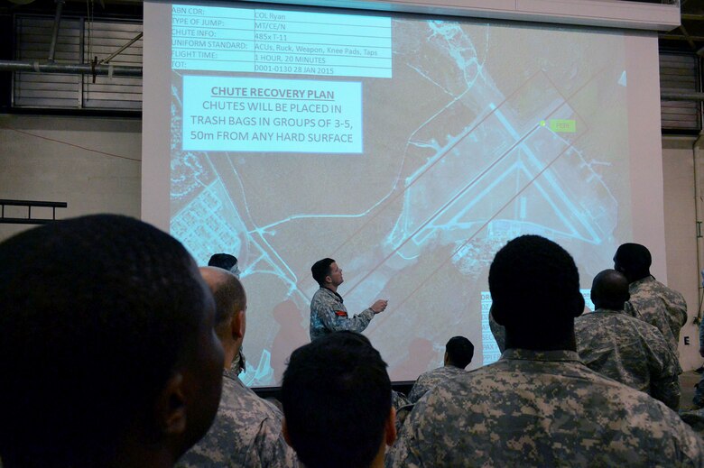 U.S. Army Sgt. 1st Class Joey Blacksher, a marshalling area control officer with the 1st Battalion, 325th Airborne Infantry Regiment, 2nd Brigade Combat Team, 82nd Airborne Division, Fort Bragg, North Carolina, briefs Commons Drop Zone procedures at Wright Army Airfield, Fort Stewart, Georgia, to Soldiers from the 2nd Brigade Combat Team, during an Emergency Deployment Readiness Exercise at Green Ramp, Pope Army Airfield, North Carolina, on Jan. 27, 2015. The Emergency Deployment Readiness Exercise assesses the 82nd Airborne Division’s deployment readiness tasks for a no-notice deployment—including alert, outload procedures, and deployment—tasks that are necessary to their mission success as the Joint Forcible Entry component of the nation's Global Response Force. (U.S. Air Force photo/Marvin Krause) 