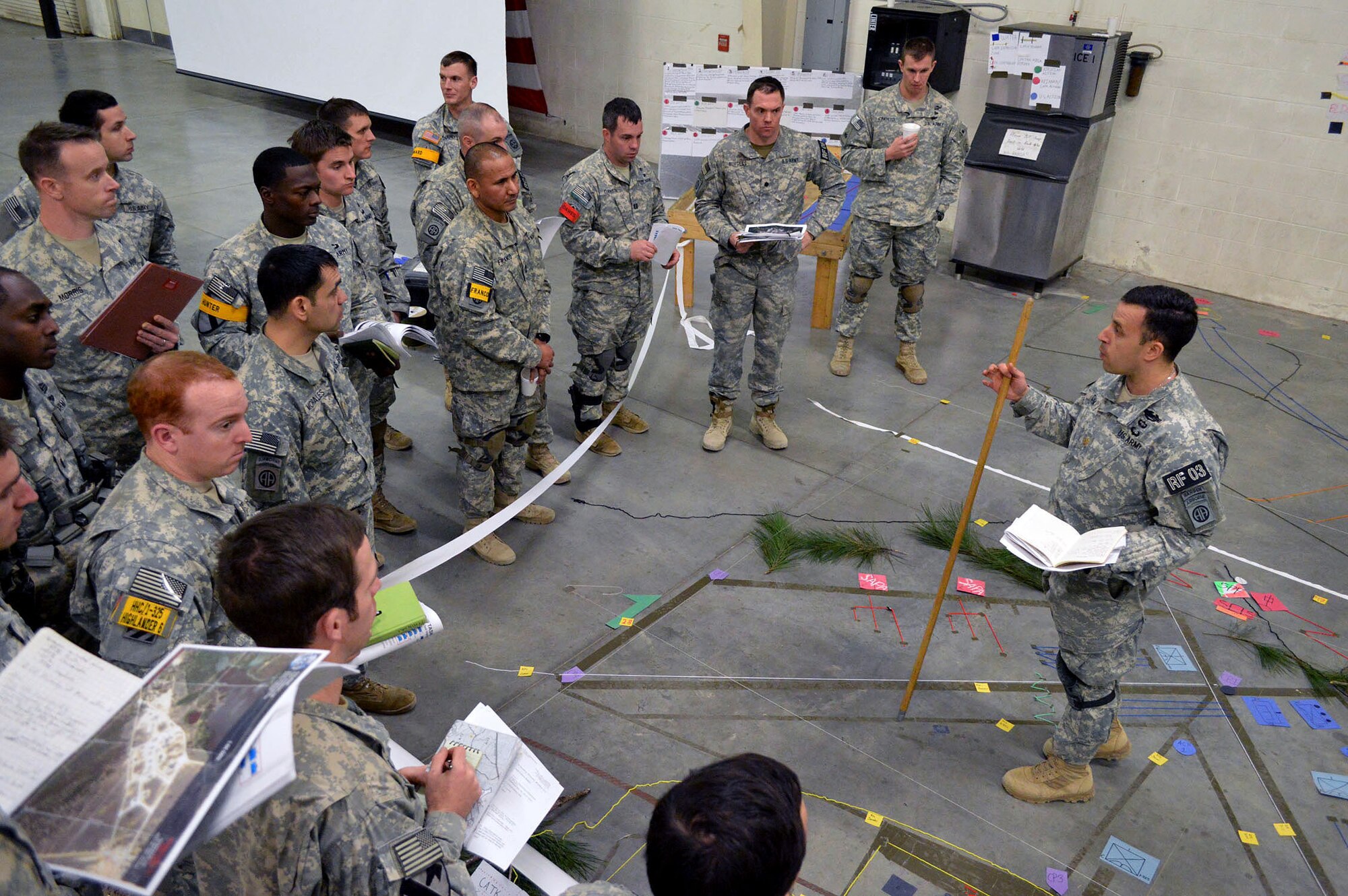 U.S. Army Maj. Joseph Da Silva, the operations officer for the 1st Battalion, 325th Airborne Infantry Regiment, 2nd Brigade Combat Team, 82nd Airborne Division, Fort Bragg, North Carolina, conducts a commander’s update briefing during an Emergency Deployment Readiness Exercise at Green Ramp, Pope Army Airfield, North Carolina, on Jan. 27, 2015. The Emergency Deployment Readiness Exercise assesses the 82nd Airborne Division’s deployment readiness tasks for a no-notice deployment—including alert, outload procedures, and deployment—tasks that are necessary to their mission success as the Joint Forcible Entry component of the nation's Global Response Force. (U.S. Air Force photo/Marvin Krause) 