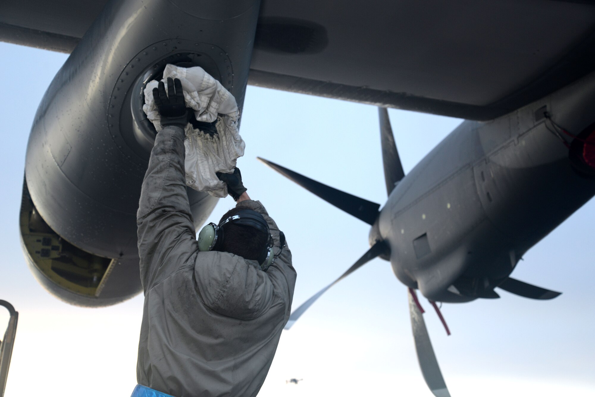 U.S. Air Force Senior Airman Warren Park, 352nd Special Operations Maintenance Squadron MC-130J Commando II crew chief from Bend, Ore., pulls out an air refueling drogue from an MC-130J Commando II during routine maintenance Jan. 29, 2015, on RAF Mildenhall, England. With shifts covering 24-hour cycles, crew chiefs perform around-the-clock maintenance ensuring all aspects of the aircraft are mission capable and ready to meet the demands of special operations. (U.S. Air Force photo by Senior Airman Kate Maurer/Released)