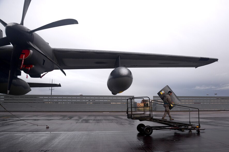 U.S. Air Force Senior Airman Warren Park, 352nd Special Operations Maintenance Squadron MC-130J Commando II crew chief from Bend, Ore., removes a panel from an MC-130J Commando II during routine maintenance Jan. 29, 2015, on RAF Mildenhall, England. With shifts covering 24-hour cycles, crew chiefs perform around-the-clock maintenance ensuring all aspects of the aircraft are mission capable and ready to meet the demands of special operations. (U.S. Air Force photo by Senior Airman Kate Maurer/Released)