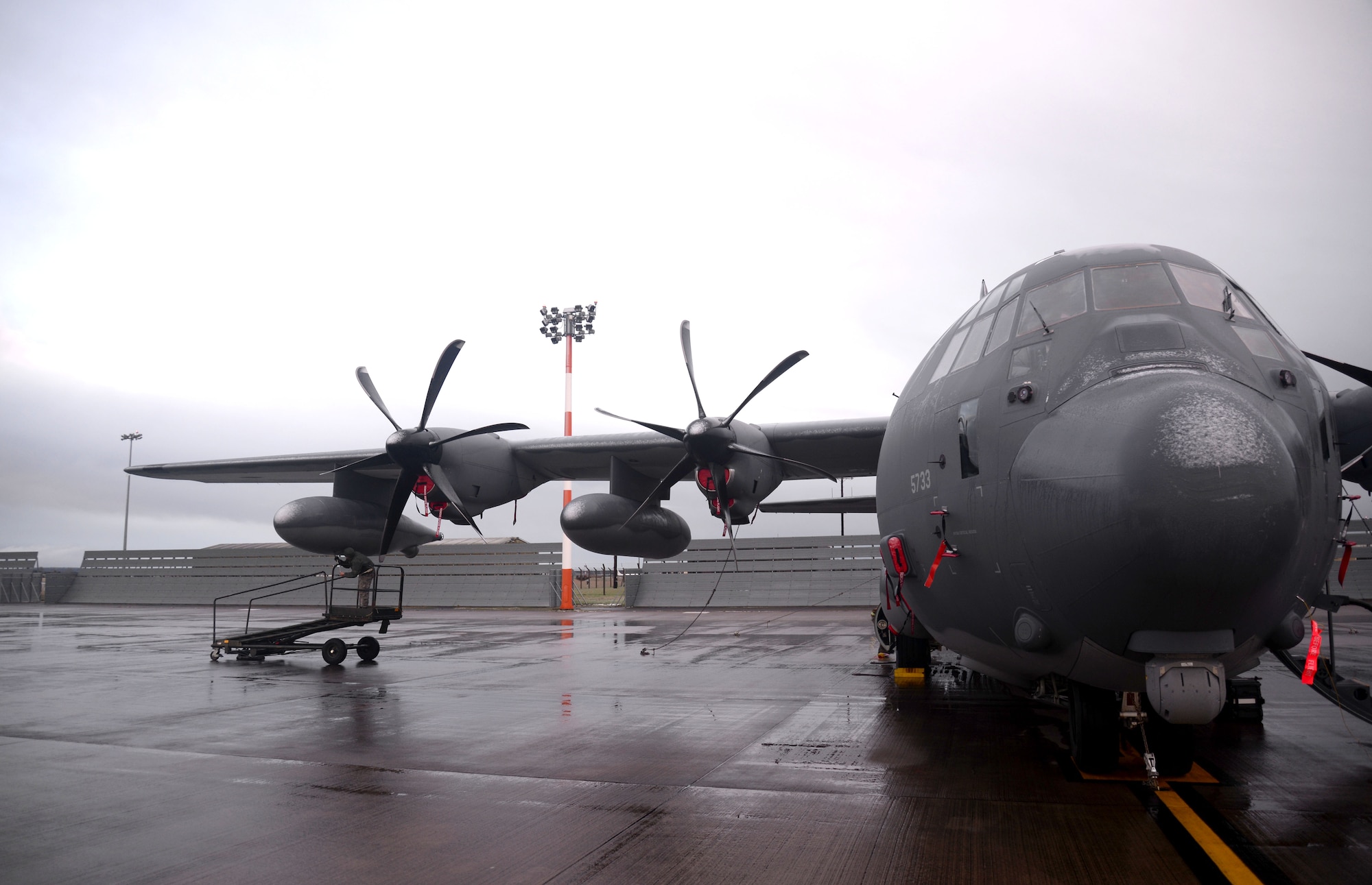 U.S. Air Force Airman 1st Class TJ Hwang, 352nd Special Operations Maintenance Squadron MC-130J Commando II crew chief from Fullerton, Calif., refastens a panel onto an MC-130J Commando II during routine maintenance Jan. 29, 2015, on RAF Mildenhall, England. With shifts covering 24-hour cycles, crew chiefs perform around-the-clock maintenance ensuring all aspects of the aircraft are mission capable and ready to meet the demands of special operations. (U.S. Air Force photo by Senior Airman Kate Maurer/Released)