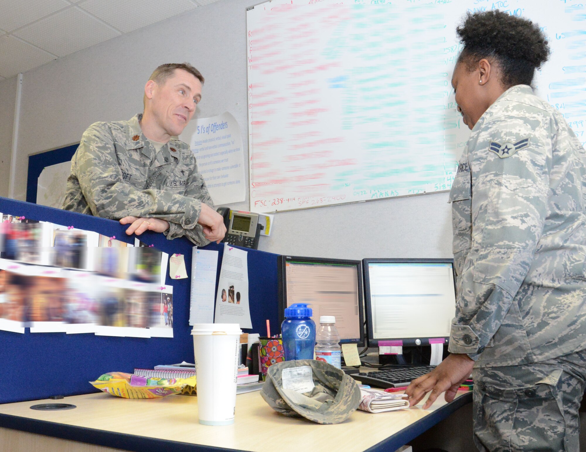 U.S. Air Force Chaplain (Maj.) Randy Croft, left, 100th Air Refueling Wing deputy chaplain from Walla Walla, Wash., visits with members of the 100th Logistics Readiness Squadron including U.S. Air Force Airman 1st Class Briauna Michel, right, 100th LRS customer support apprentice from Chicago Feb. 3, 2015, on RAF Mildenhall, England. Croft ensures Airmen and their families are connected and aware of resources to strengthen their families, marriages, relationships and spiritual resilience. (U.S. Air Force photo illustration by Gina Randall/Released)