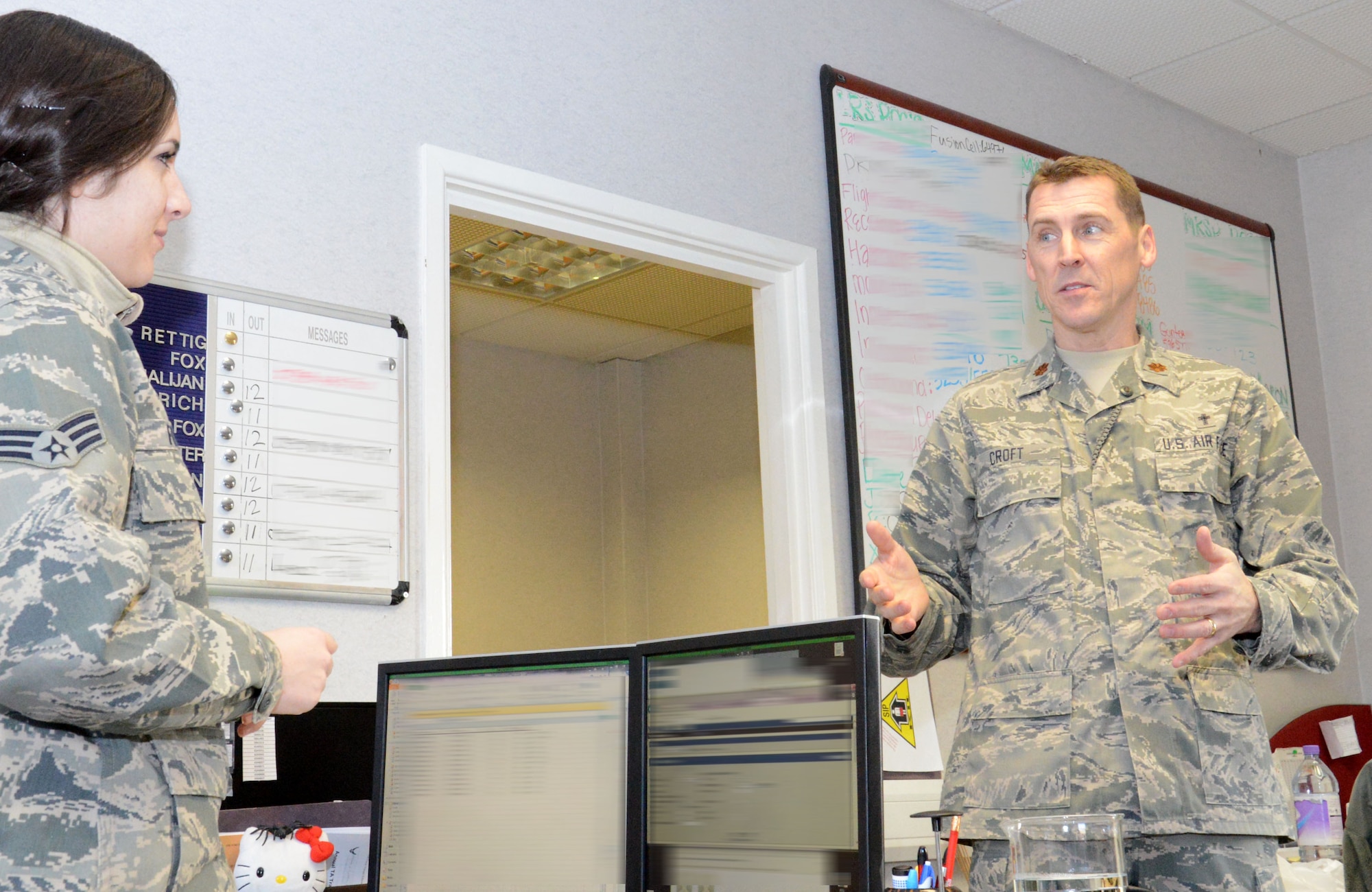 U.S. Air Force Chaplain (Maj.) Randy Croft, right, 100th Air Refueling Wing deputy chaplain from Walla Walla, Wash., visits with members of the 100th Logistics Readiness Squadron including U.S. Air Force Senior Airman Jazmine Fox, left, 100th LRS customer support journeyman from Ontario, Calif., Feb. 3, 2015, on RAF Mildenhall, England. The chaplains on base divide the squadrons amongst themselves so they have their own and are able to spend extra time with the people. (U.S. Air Force photo illustration by Gina Randall/Released)
