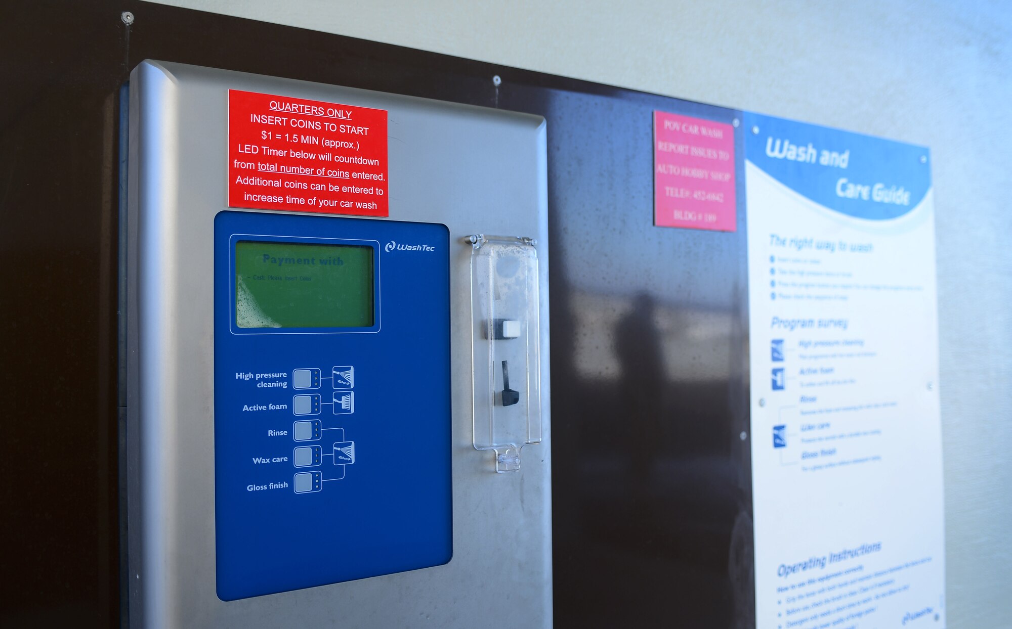 A pay machine sits inside one of the stalls at the newly opened self-service carwash at Spangdahlem Air Base, Germany, Feb. 4, 2015. The machine accepts quarters only. The carwash also has a change machine located outside of it that accepts $1, $5 and $10 bills. (U.S. Air Force photo by Airman 1st Class Luke Kitterman/Released)